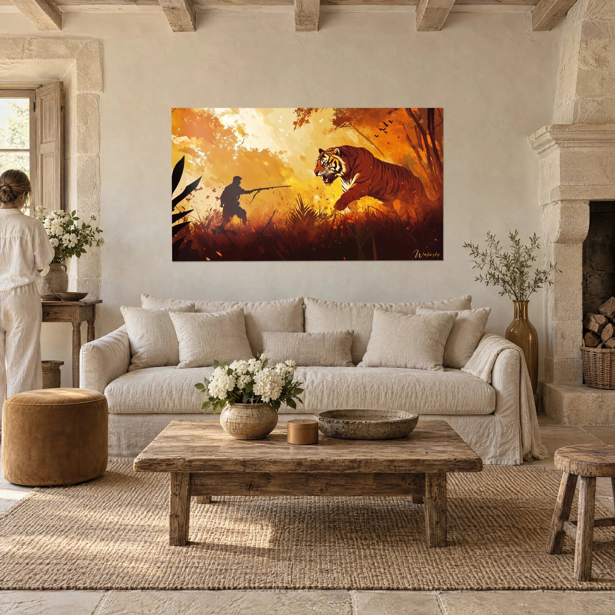 Wall art of a leaping tiger with brown stripes facing a hunter in silhouette, yellow and orange background, above a sofa in a bright living room