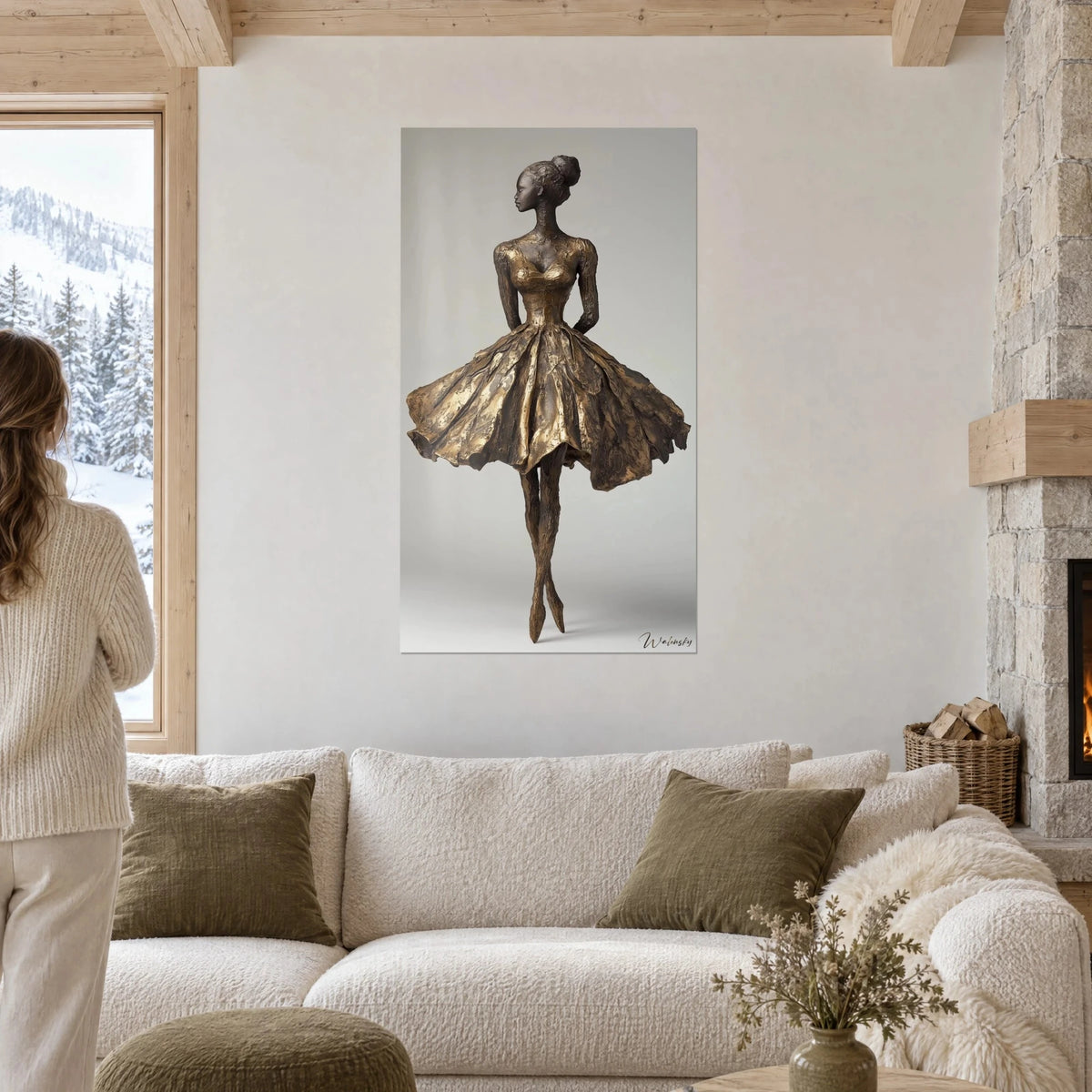 Wall art ballerina sculpture in gilded bronze, corolla-style skirt with scaled pleats, on a pearl grey background, above a sofa in a bright living room
