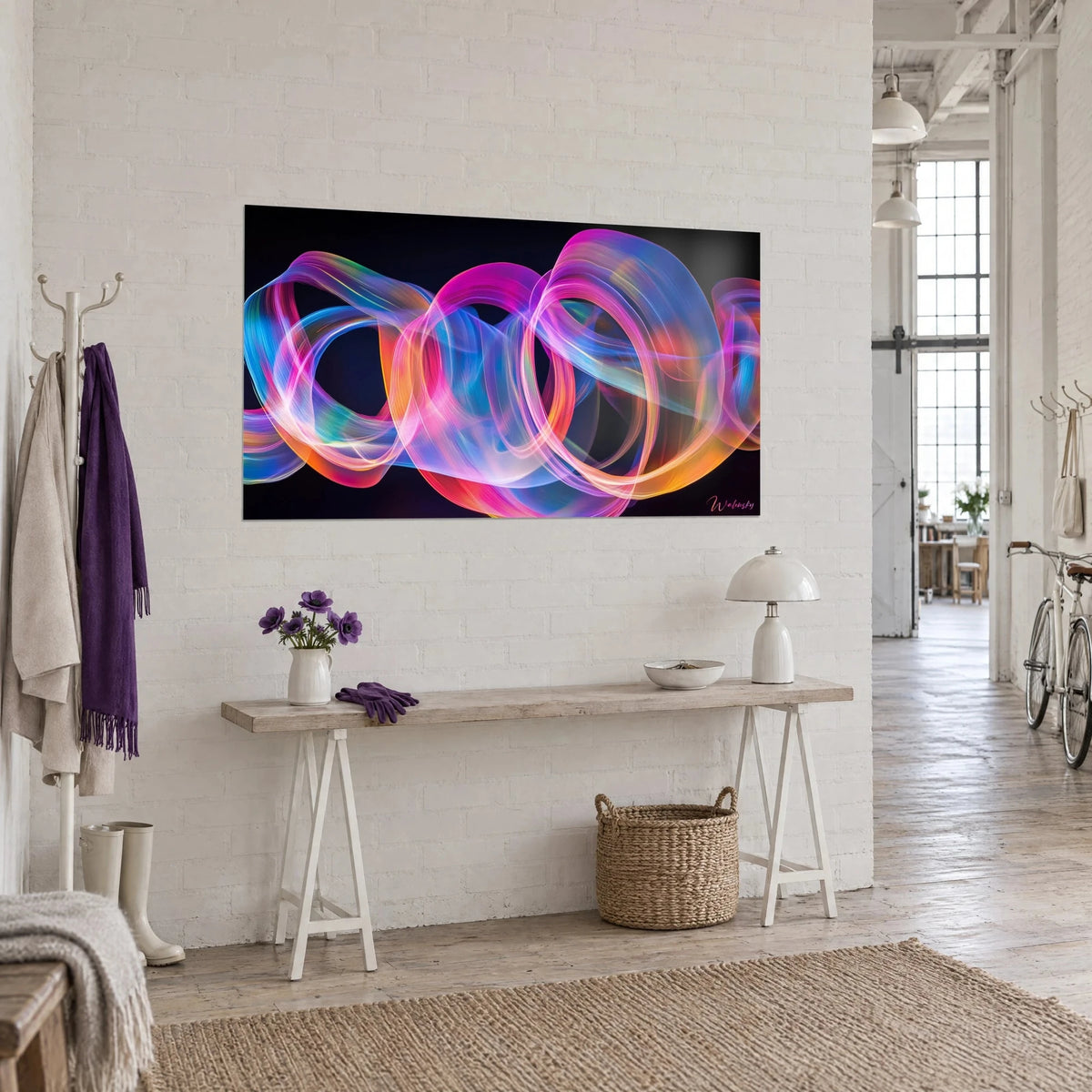 Wall art of translucent loops in vivid pink, golden orange and electric blue, seen from three-quarters above a console table