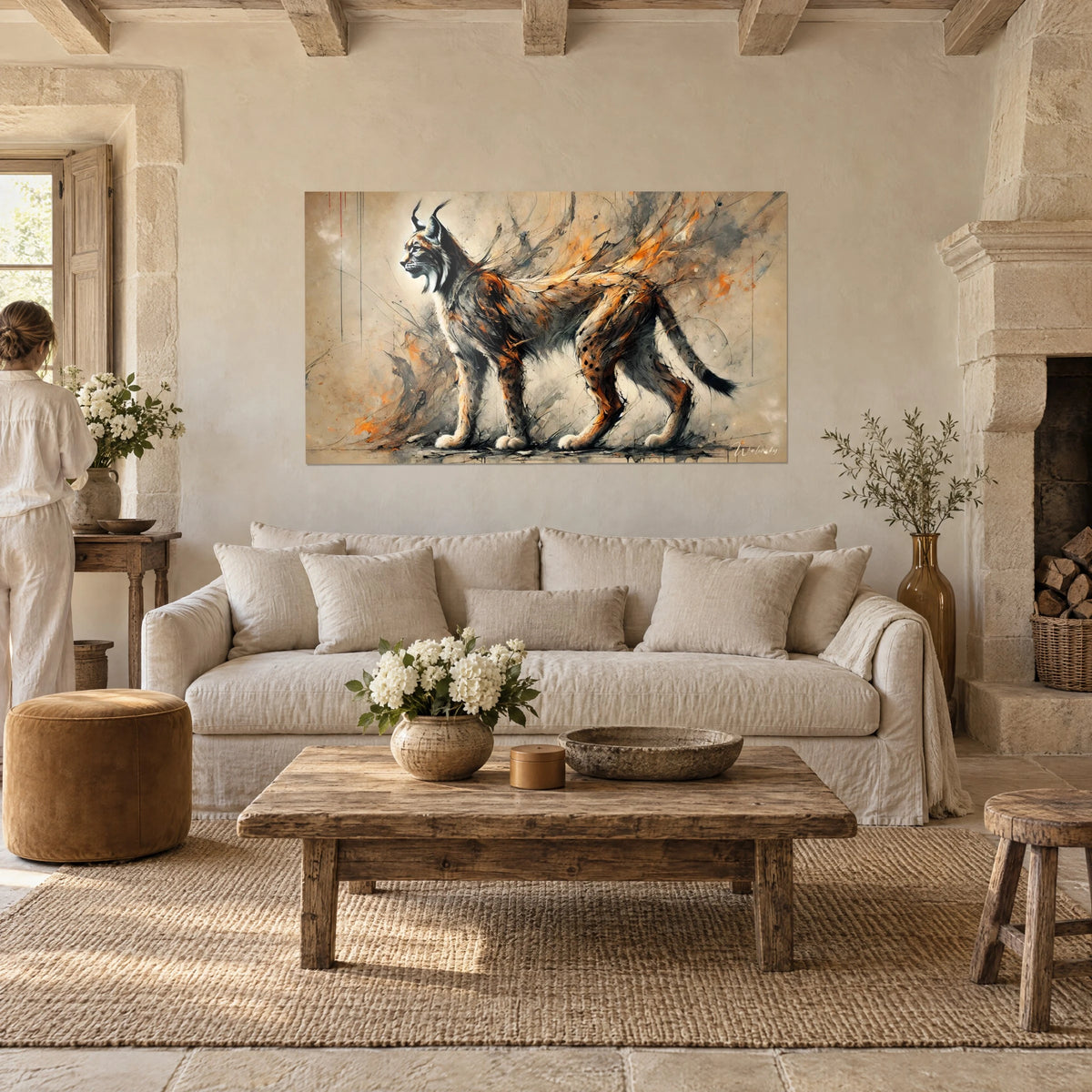 Wall art lynx in profile with black ear tufts, reddish and grey fur, above a sofa in a bright living room