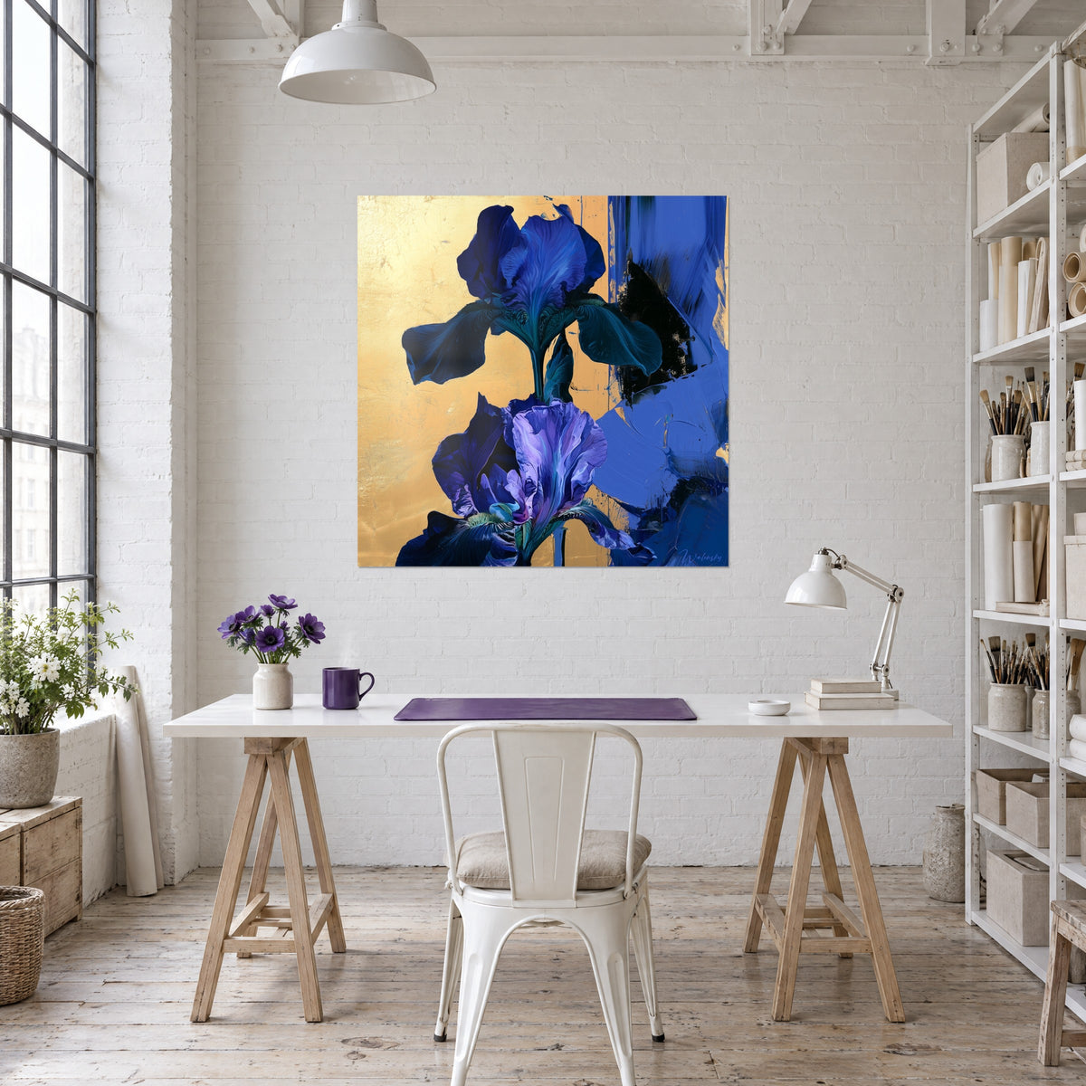 Wall art azure and violet orchid-iris, brilliant gold leaf and blue impasto, hung behind a white desk with flowers