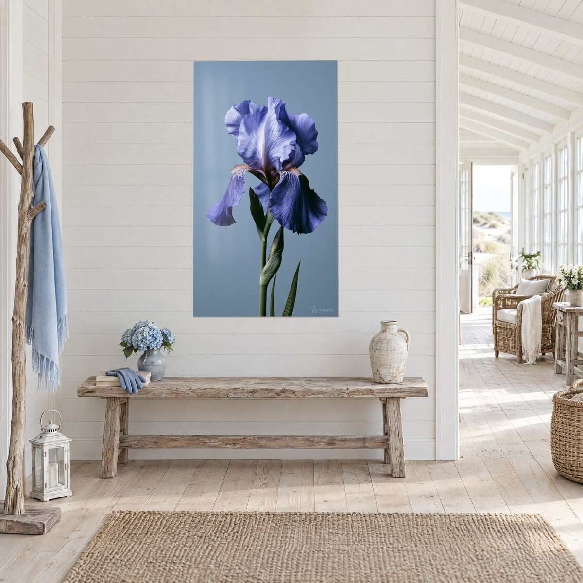 Wall art purple iris bloom and green stem on grey-blue background, three-quarter view beside a rough wooden bench
