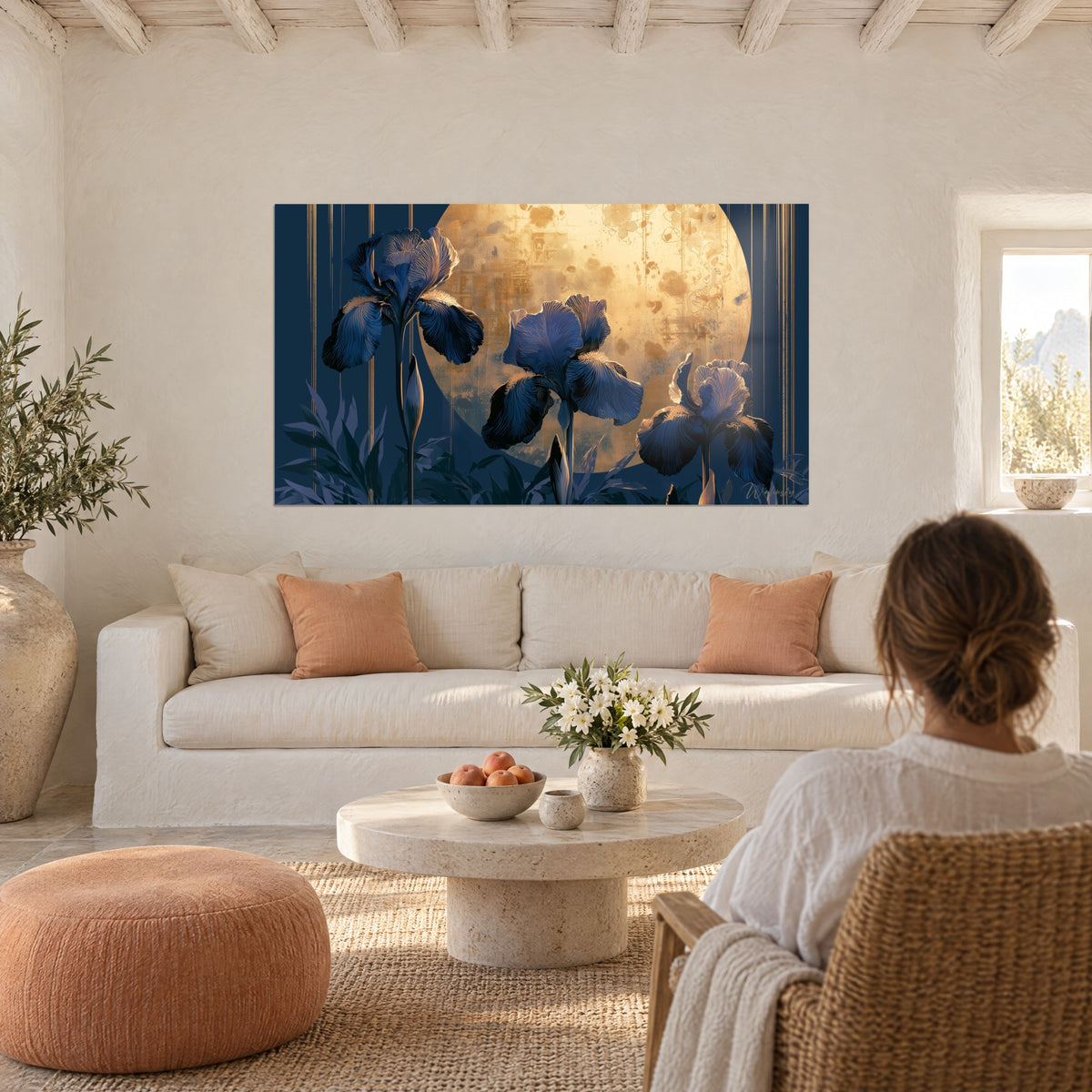 Wall art of navy blue irises under an ochre moon with golden glints, fine gold lines, woman seen from behind, above a sofa in a bright living room
