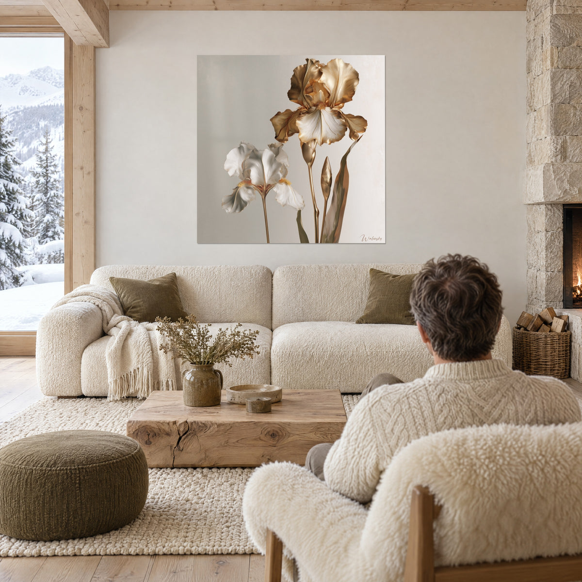 Wall art ivory iris with gilded ruffles, two blooms on greige background, man seen from behind above a sofa in a bright living room