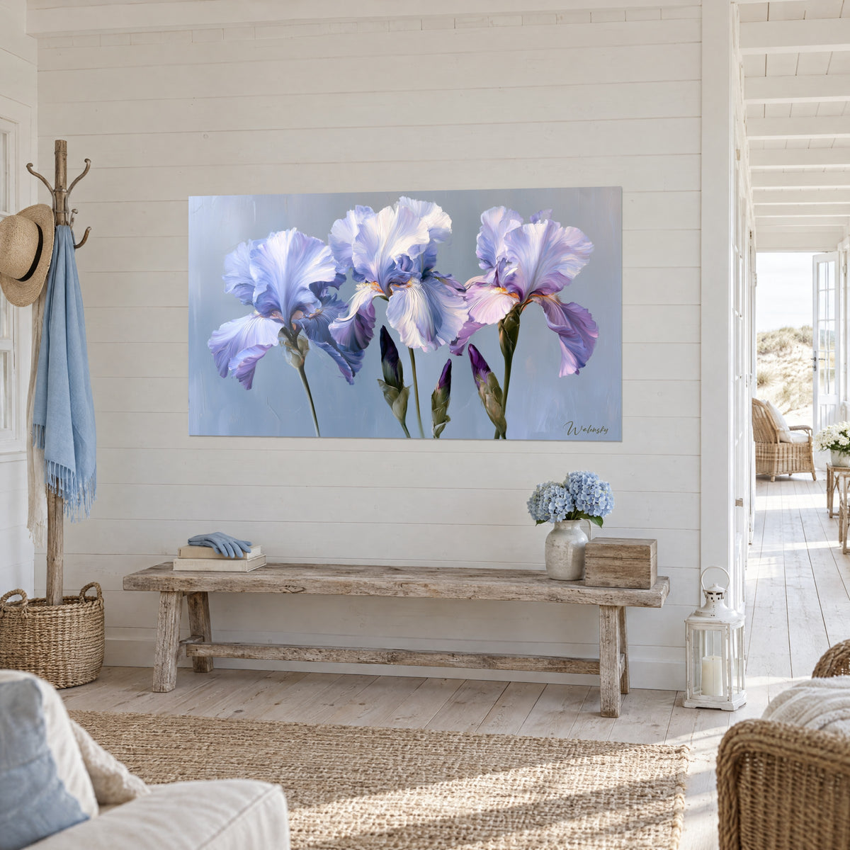 Wall art iris flowers in lilac and cream white, olive green stems, hung at an angle above a light wood bench