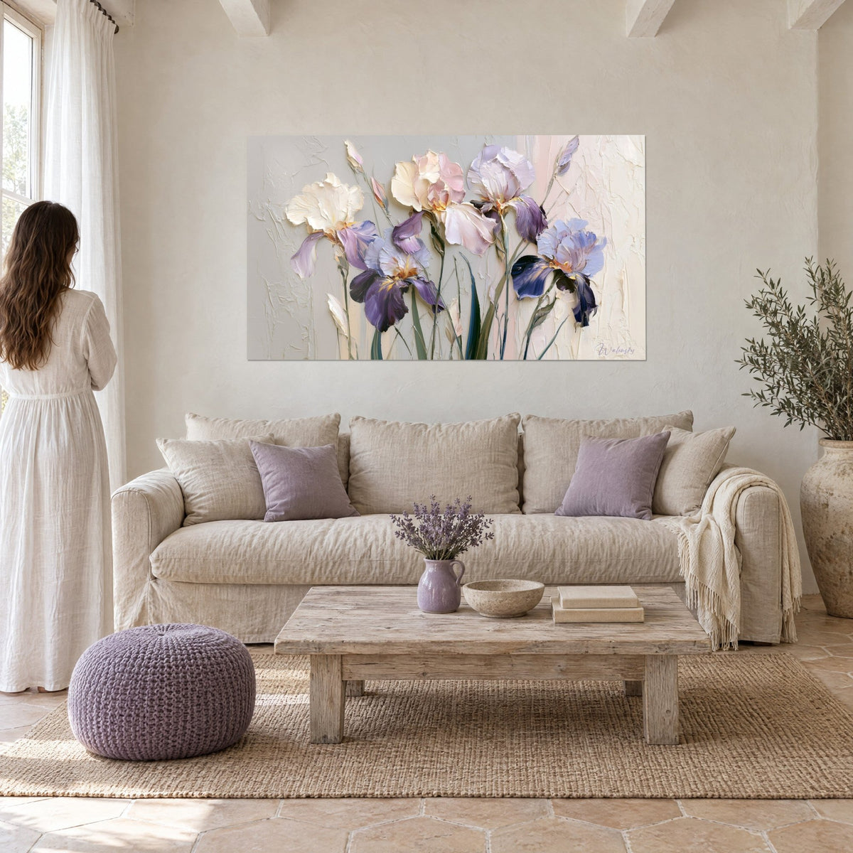 Wall art cream and plum iris with raised impasto texture, woman in a white dress seen from behind, above a sofa in a bright living room