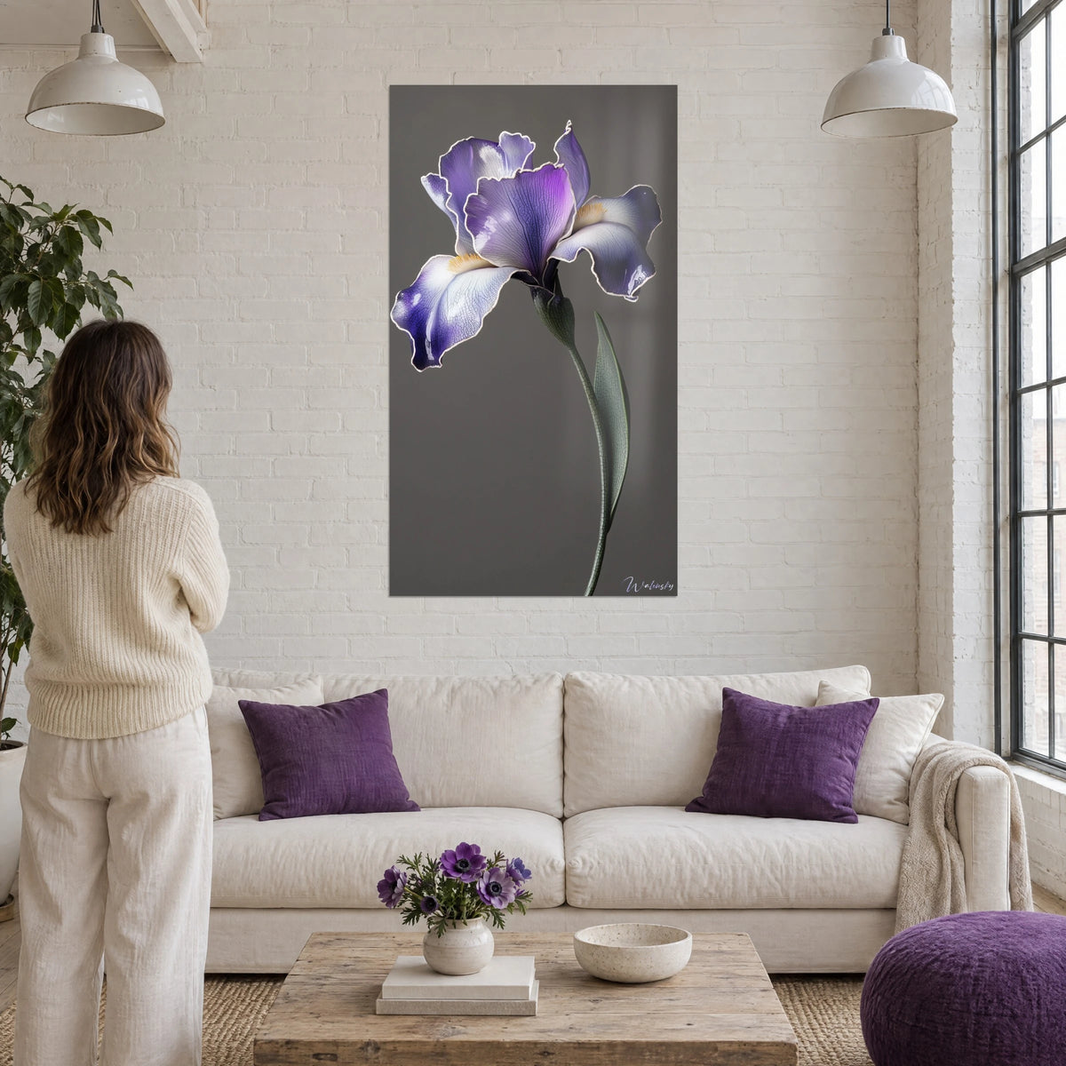 Wall art purple iris with wavy petals edged in white on a grey background, above a sofa in a bright living room