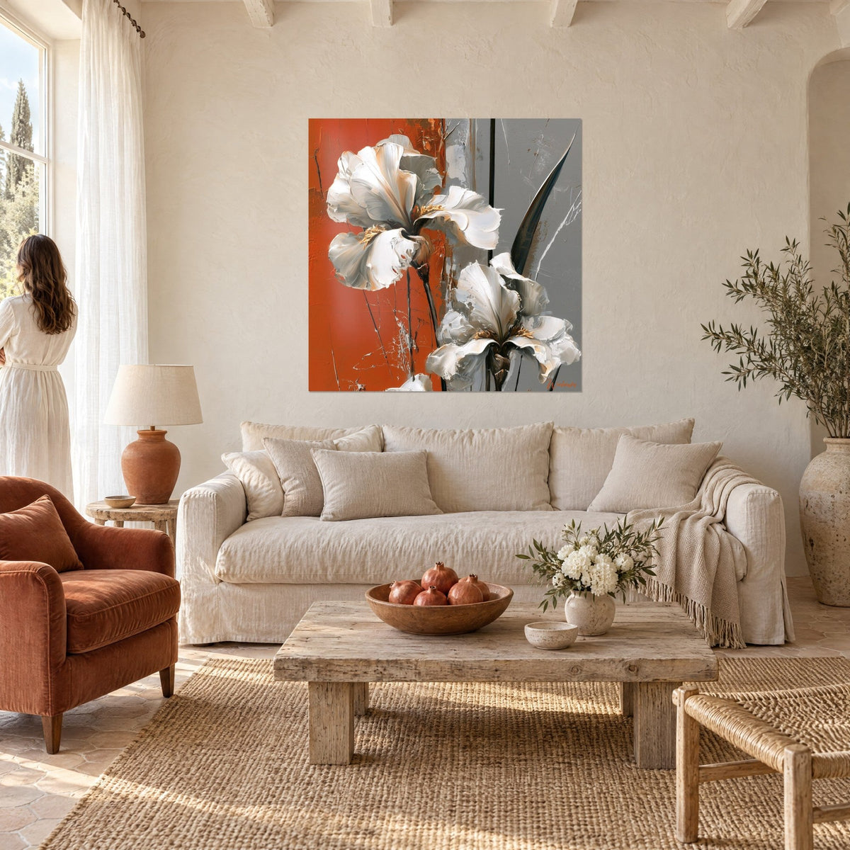 Wall art white iris blooms in thick impasto on terracotta and grey background, golden stamens, woman seen from behind, above a sofa in a bright living room