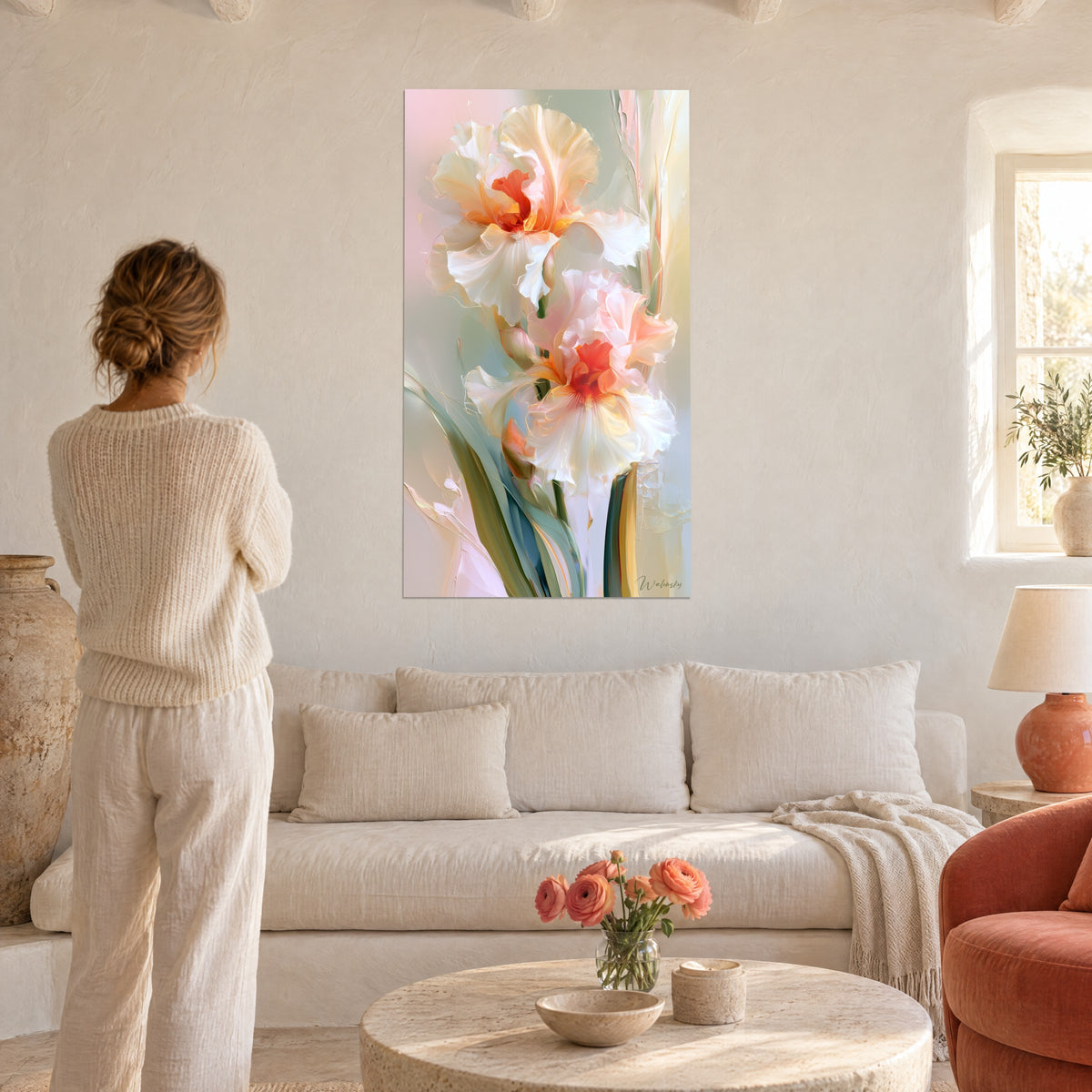 Wall art with cream-white iris flowers and coral hearts, wavy petals cascading, above a sofa in a bright living room