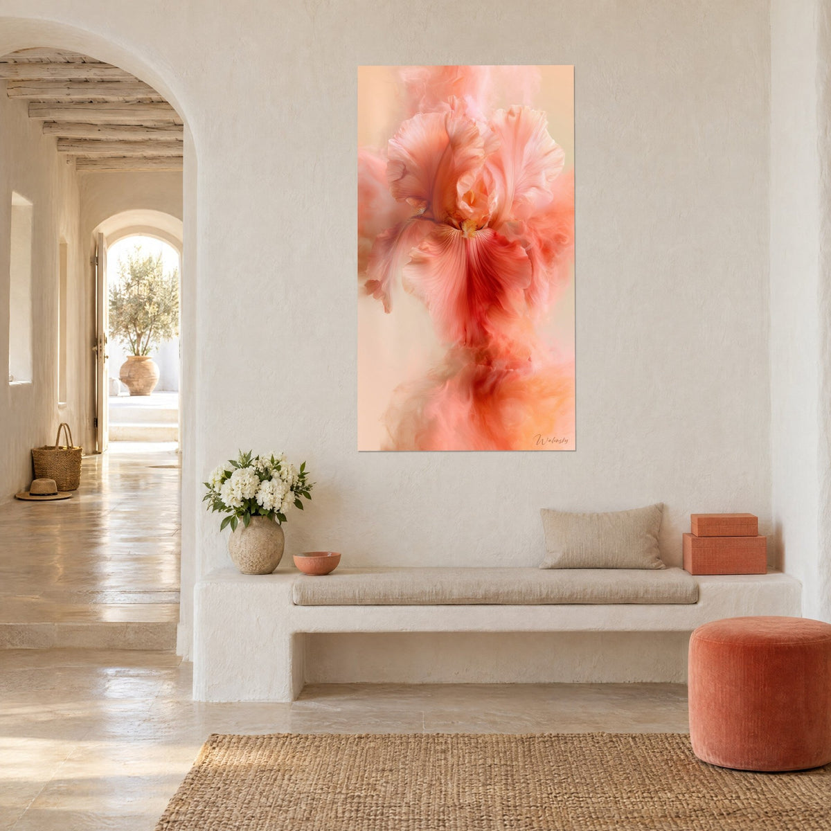 Wall art iris bloom in salmon and carmine red with misty swirls, hung on a whitewashed wall, white bench and terracotta pouf