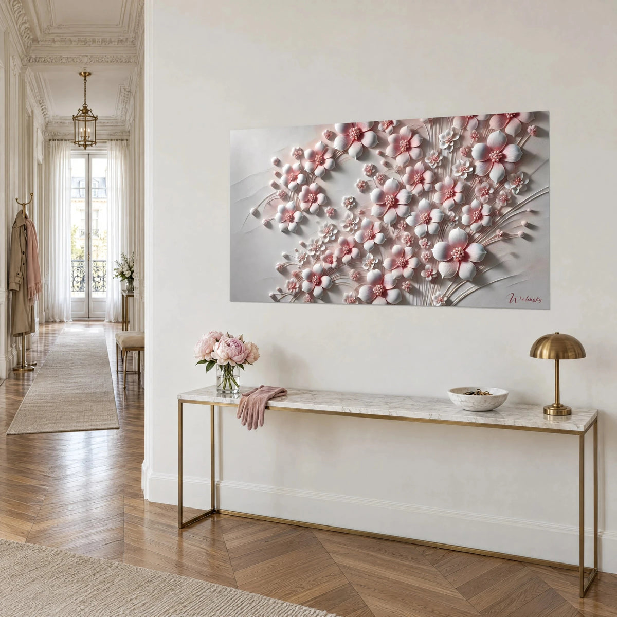 Wall art sculpted floral bloom with pearly pale pink and white petals, golden hearts and slender stems, on a brass and marble console