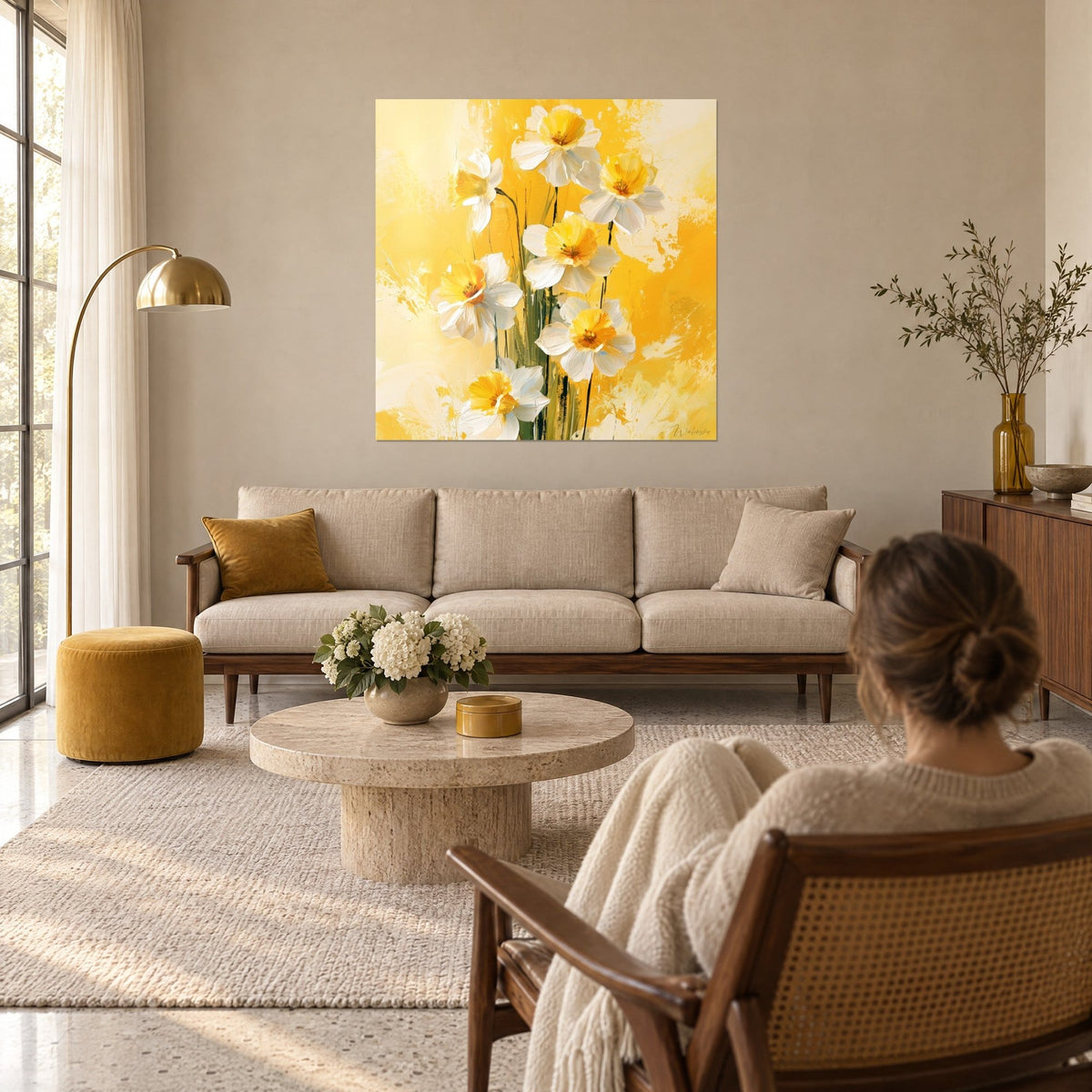Wall art white daffodils with yellow hearts on saffron background, green paint drips, above a sofa in a bright living room
