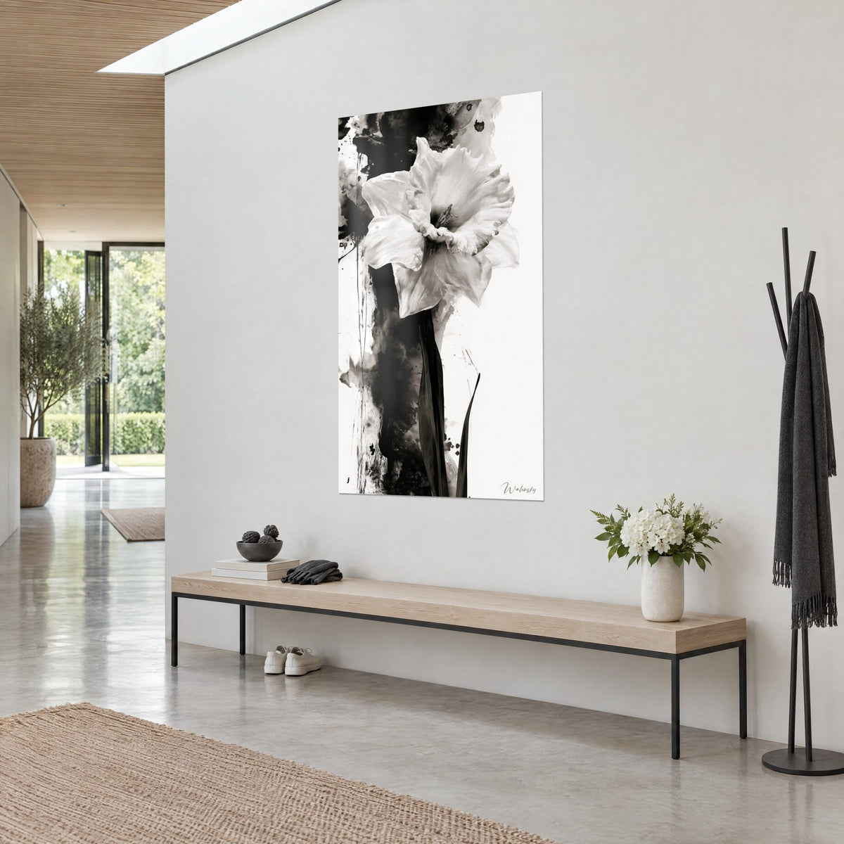 Wall art of an ivory daffodil with crumpled petals on black ink and cream-white background, three-quarter view, light oak bench