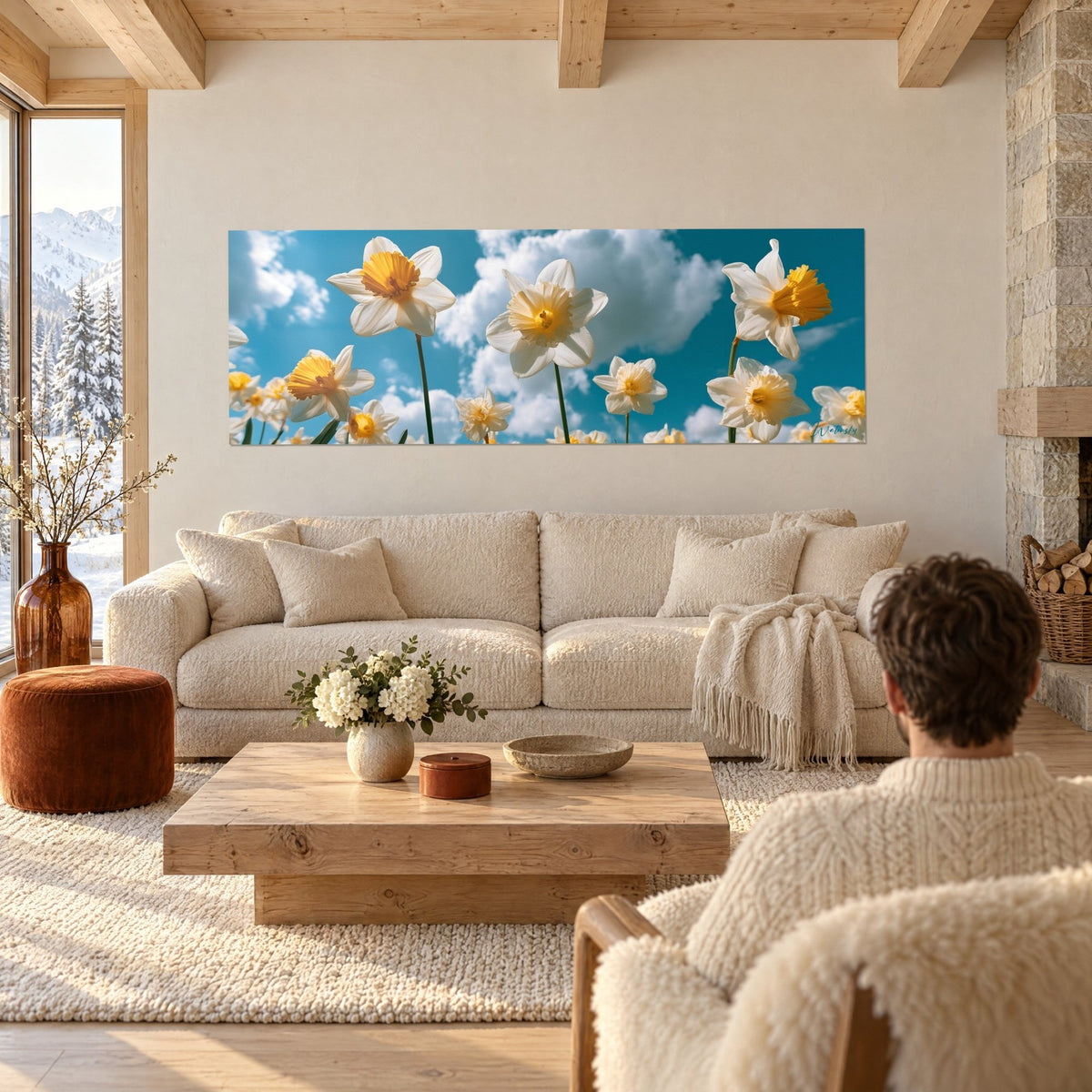 Schilderij van witte narcissen met gele kern, van onderaf gezien tegen een blauwe lucht, boven een bank in een lichte woonkamer