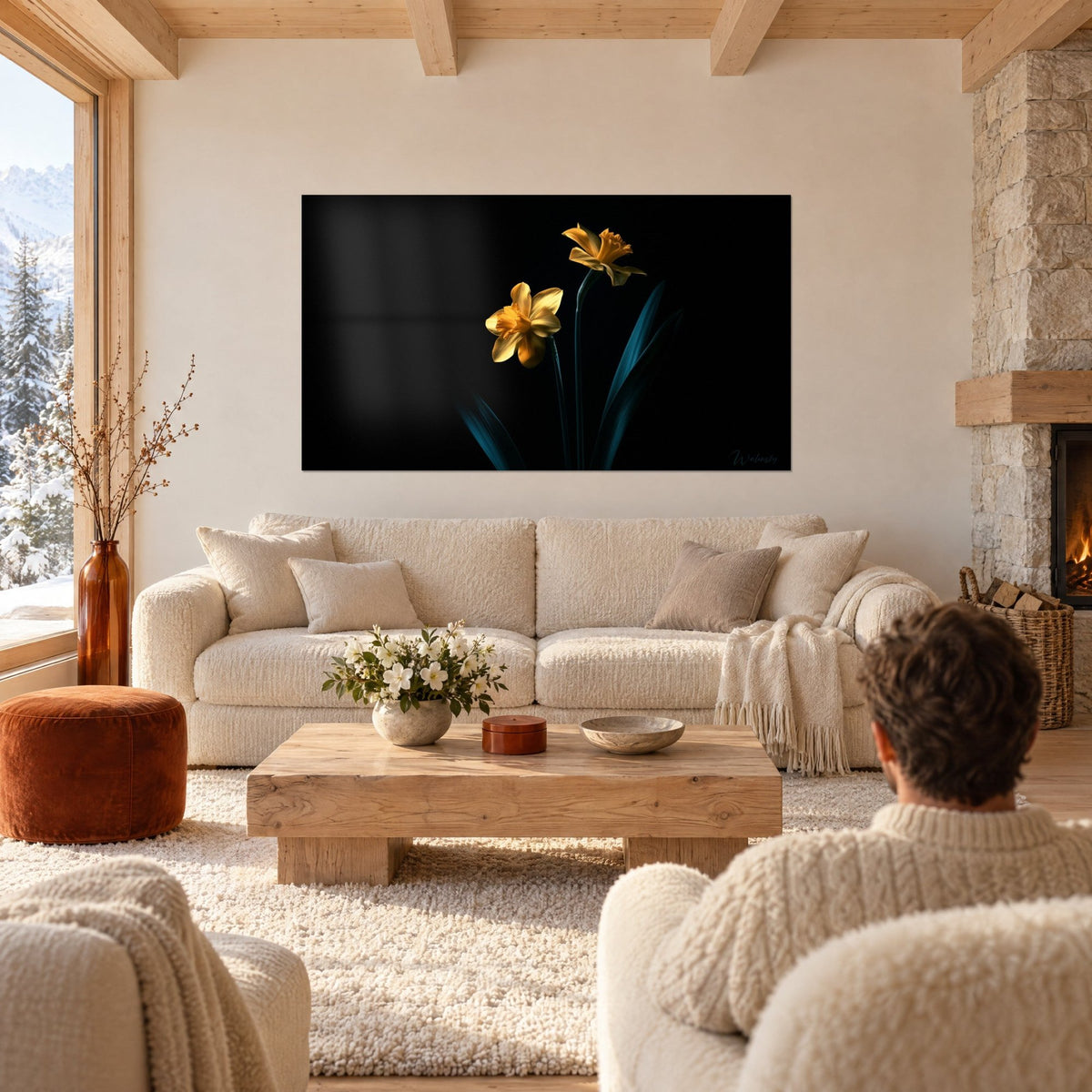 Wall art golden daffodils on black background, petrol blue leaves, above a sofa in a bright living room