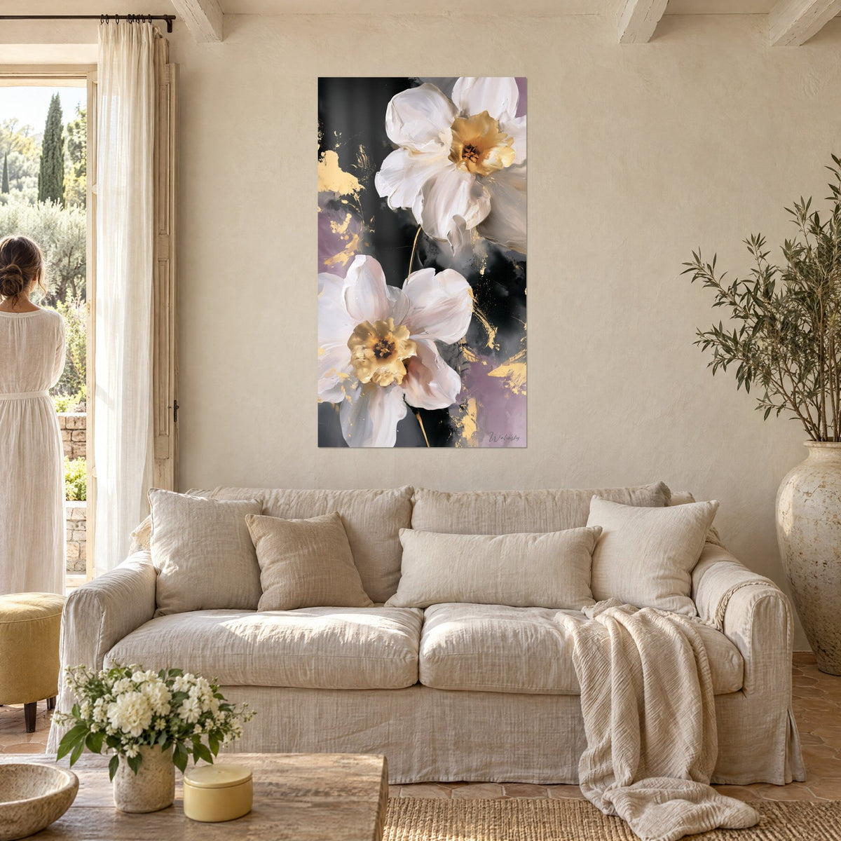 Wall art white daffodils with golden hearts on black and mauve background, a woman seen from behind, above a sofa in a bright living room
