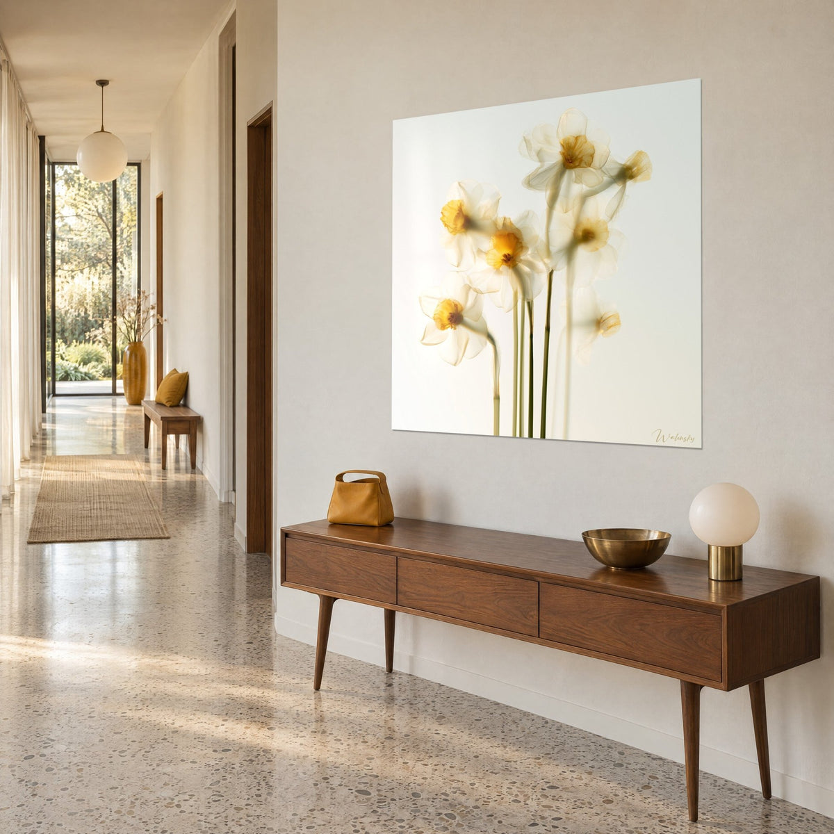 Wall art with translucent daffodil flowers, ivory and saffron-yellow blooms on a white background, hung above a wooden console table