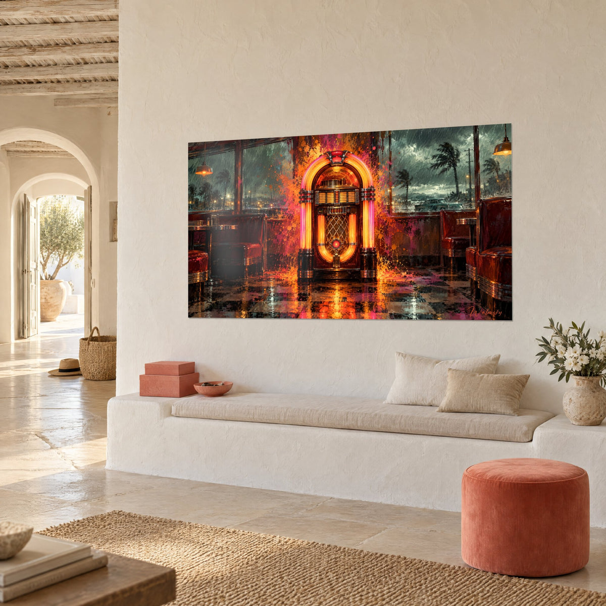 Tableau borne de musique rétro cernée de gouttes magenta, banquettes rouge bordeaux, vue de trois-quarts sur mur blanc et banquette en pierre