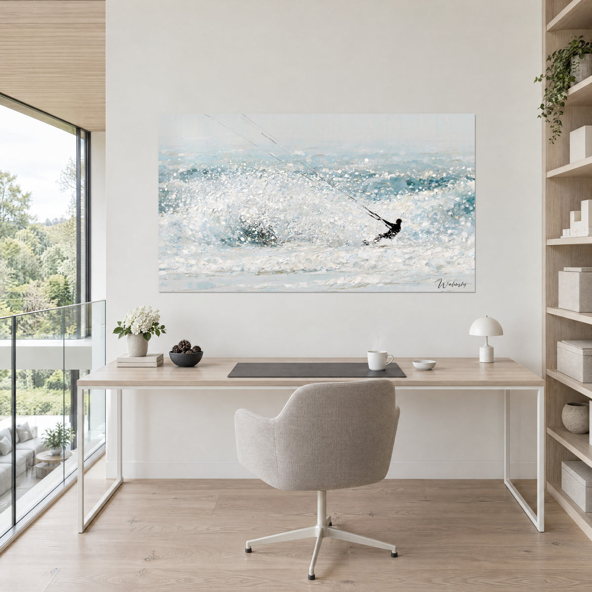 Wall art black watersports rider backlit in sparkling white and celadon-blue spray, hung above a light wood desk
