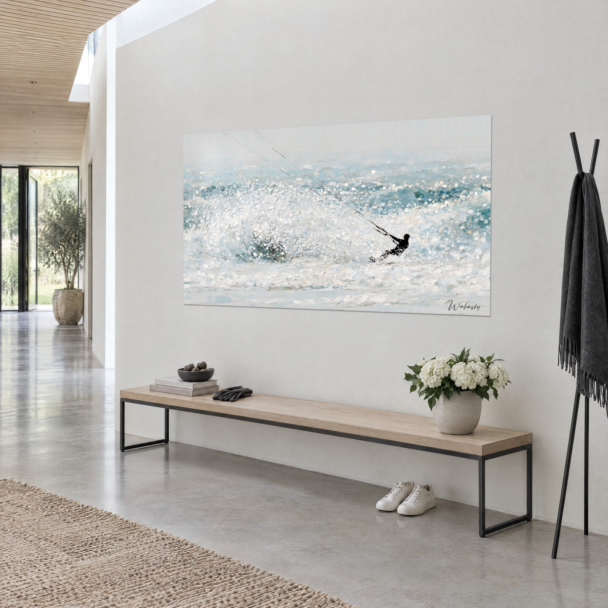 Wall art spray of sparkling white and turquoise sea mist, black kiter pulled by his fine lines, seen three-quarter view on a light wall