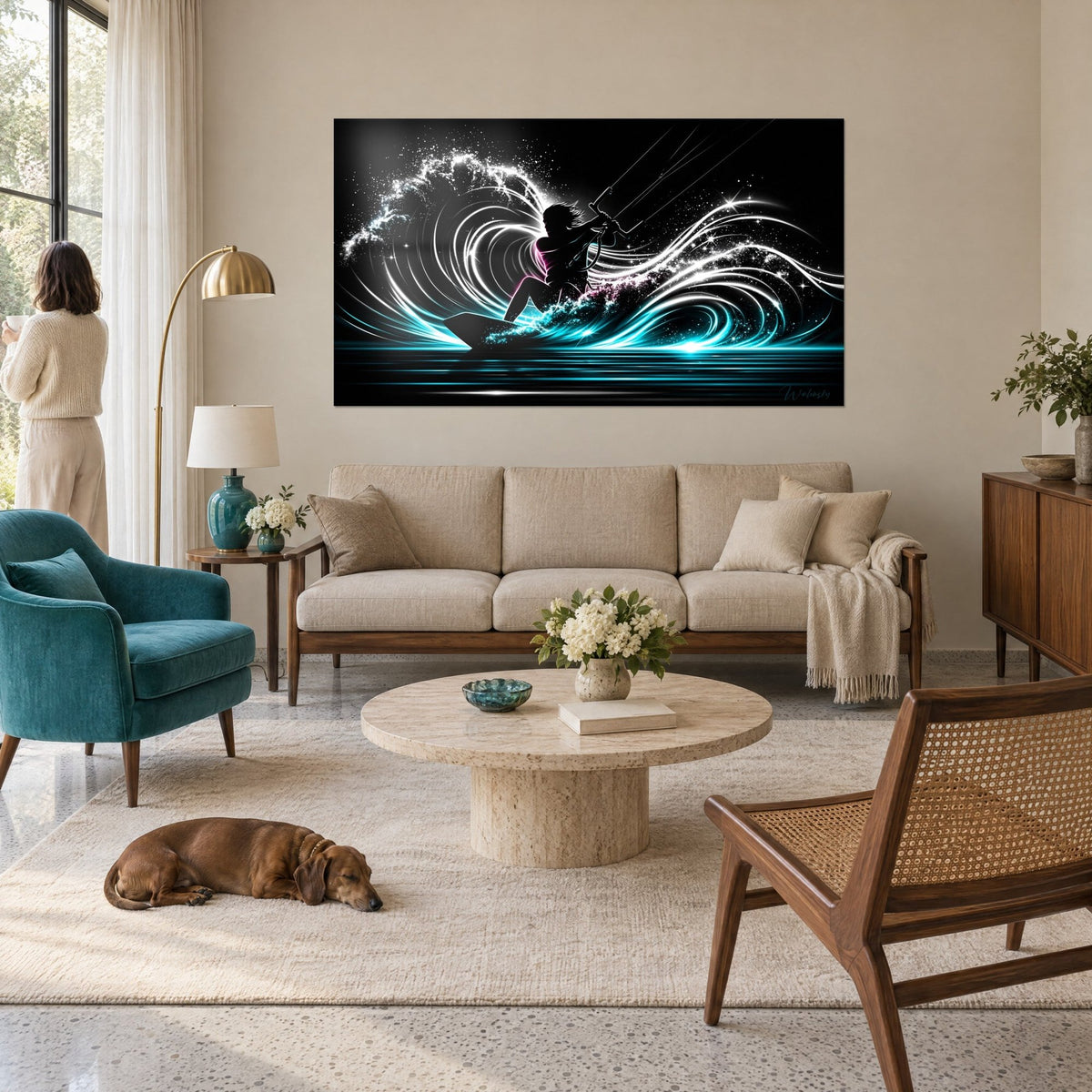 Wall art of a kitesurfer in black silhouette, turquoise wave and sparkling white spray, above a sofa in a bright living room