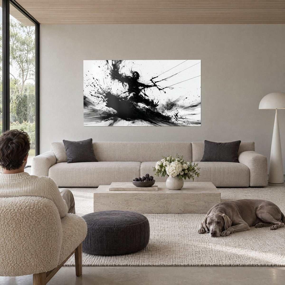 Tableau kitesurfeur aux cheveux longs en encre noire projetée sur fond blanc, voiles et éclaboussures, au-dessus d'un canapé dans un salon lumineux