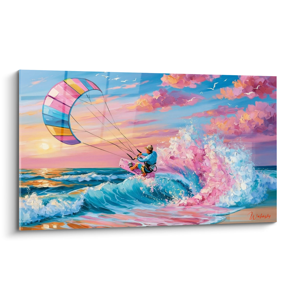 Kitesurfeur en équilibre sur une vague turquoise, voile rose et bleue face au soleil couchant