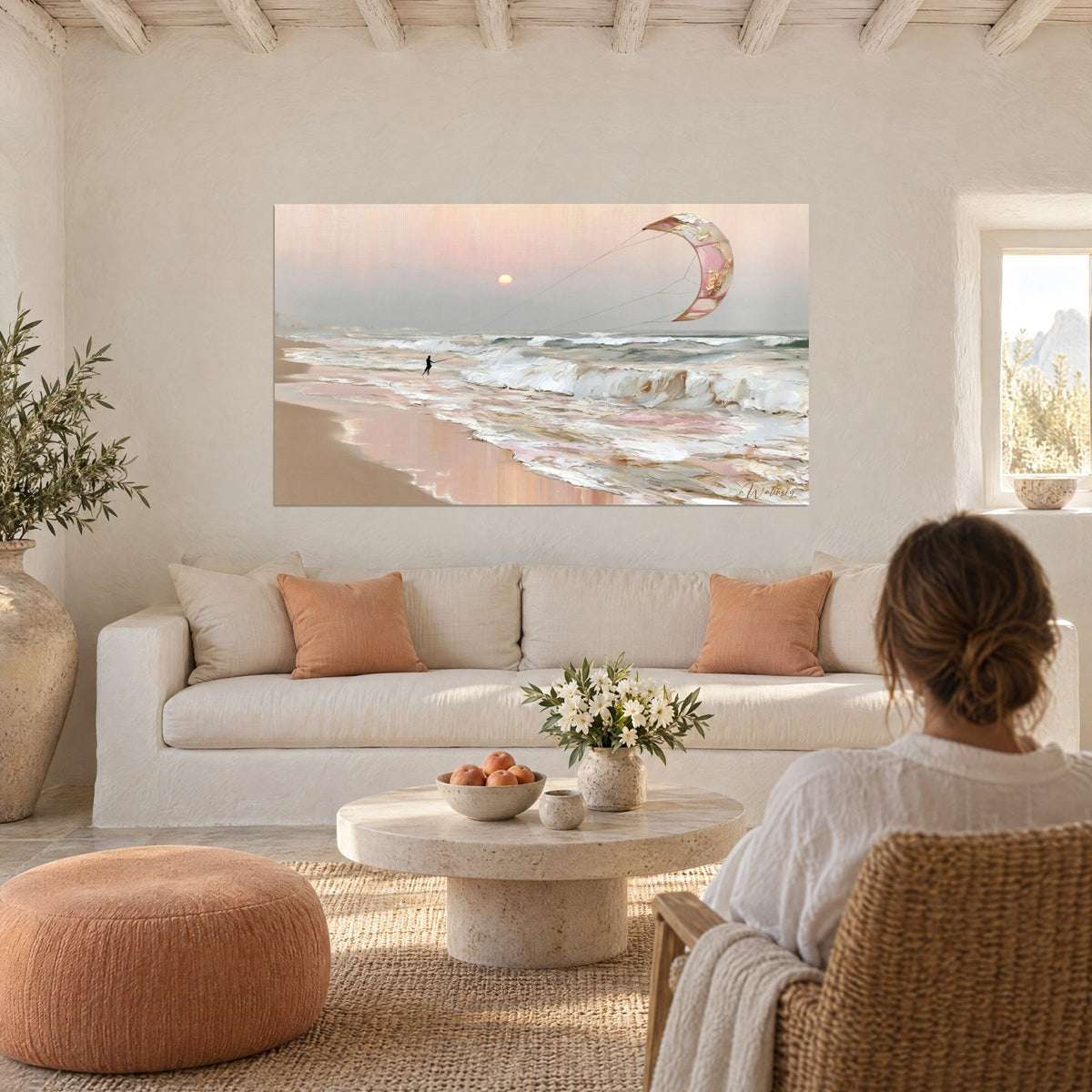 Wall art kitesurfer gliding over pink and golden foam, pale sun, above a sofa in a bright living room