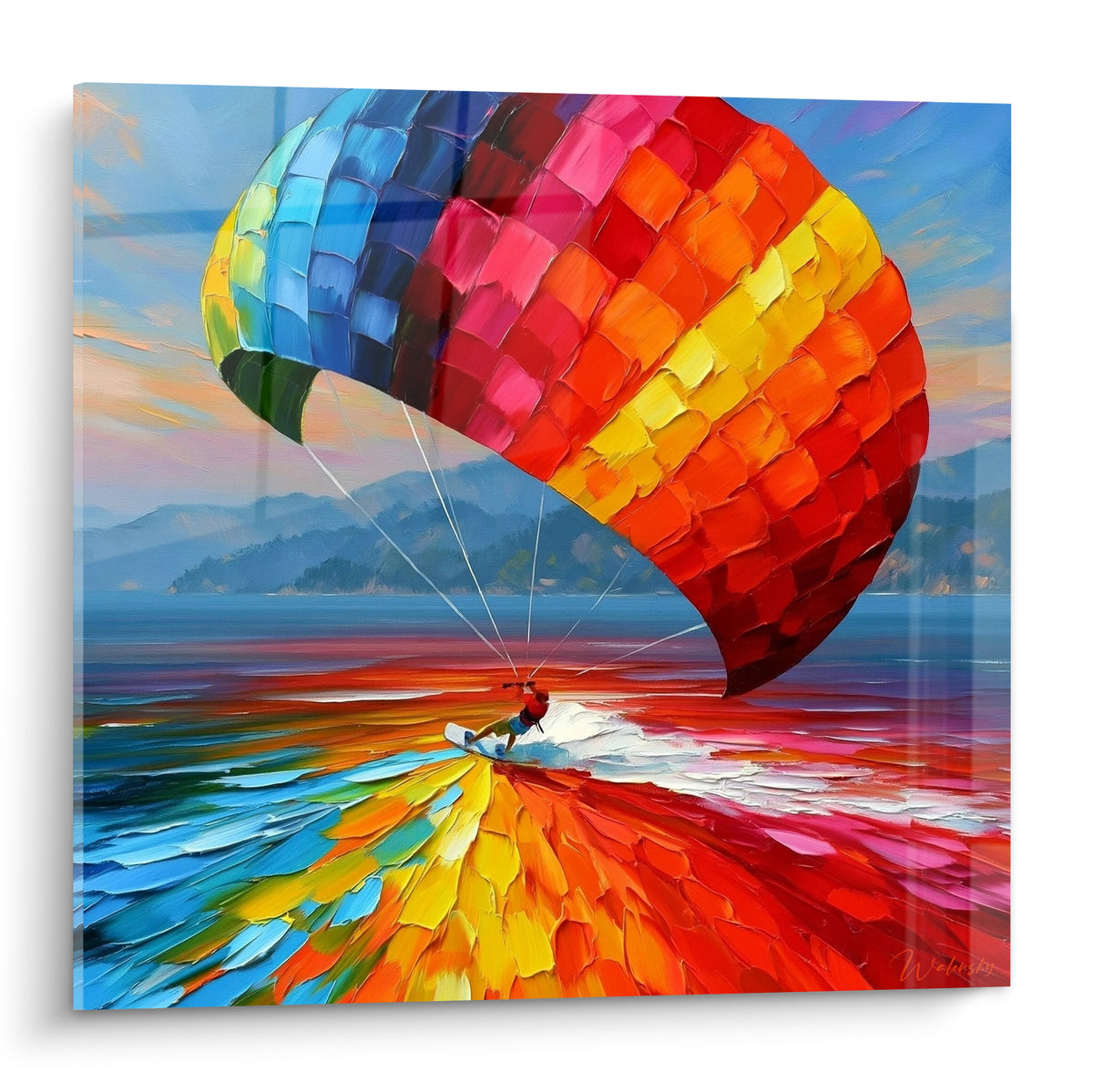 Kitesurfeur glissant sous une voile bleu marine et rouge orangé sur mer turquoise éclatante