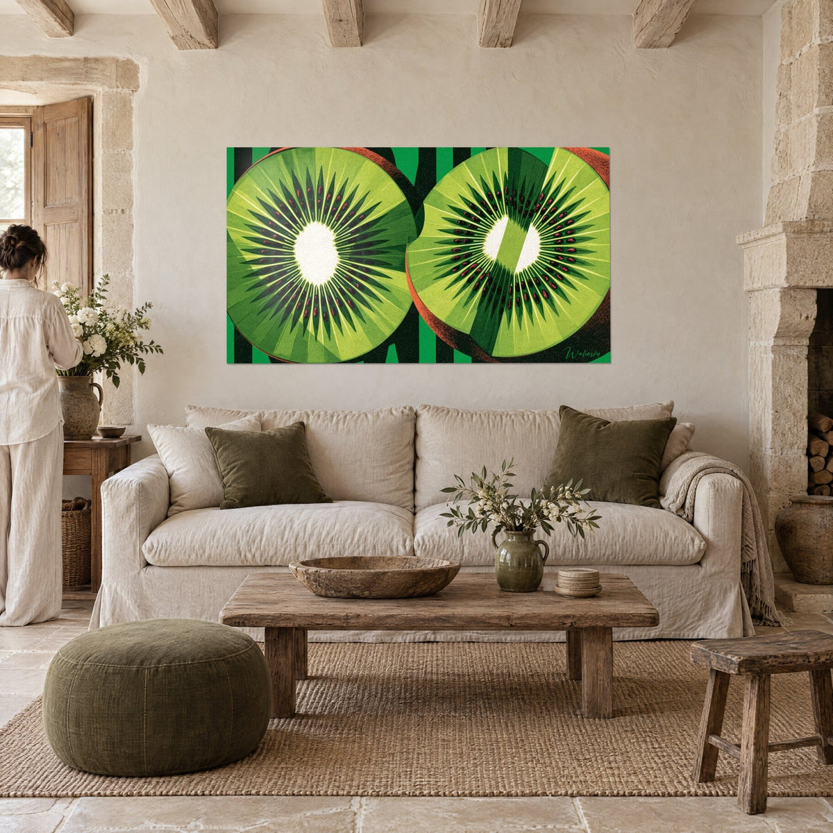 Wall art of halved kiwis, anise-green flesh and garnet seeds on black stripes, above a sofa in a bright living room