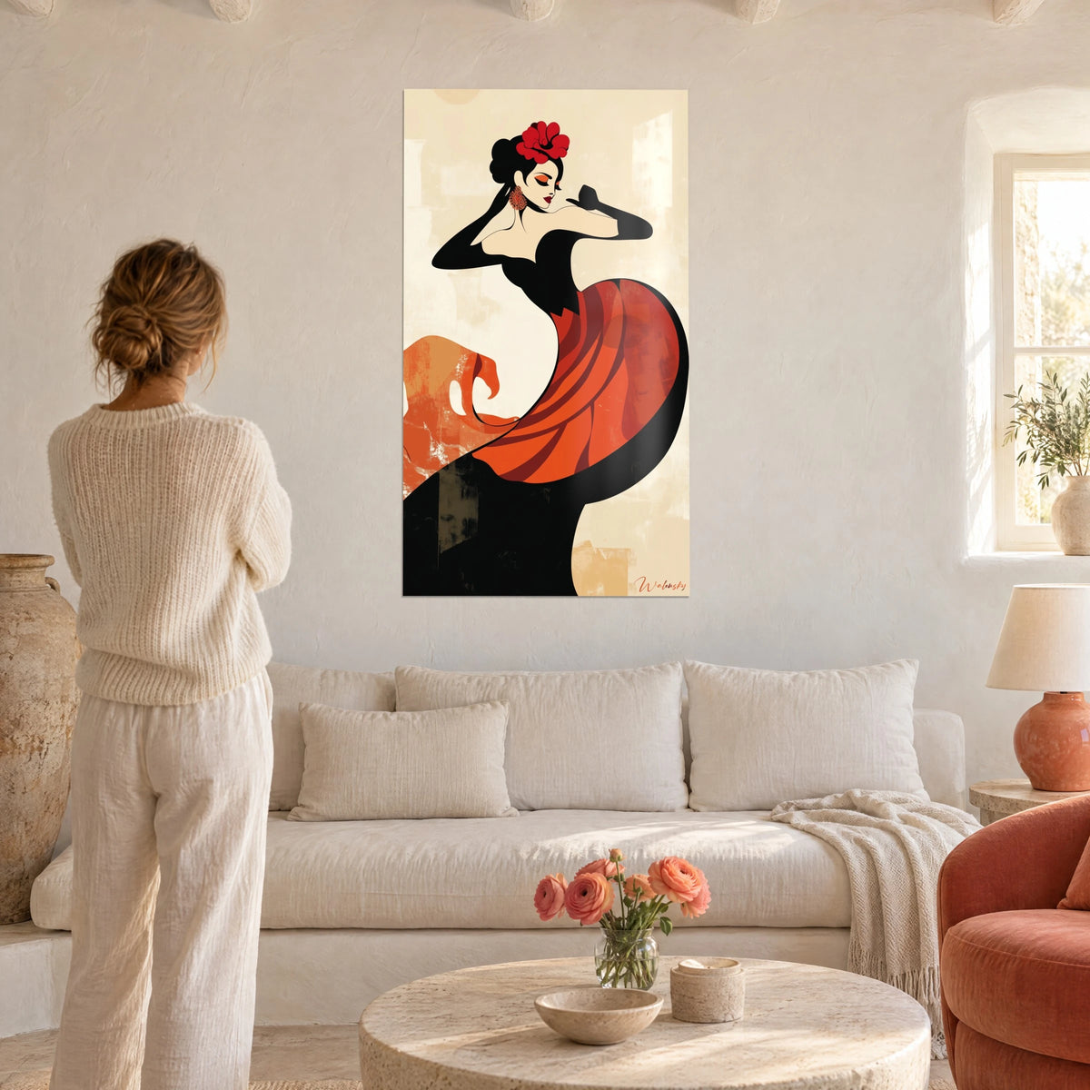 Wall art flamenco dancer in a coral red and black dress, scarlet flower in her hair, above a sofa in a bright living room