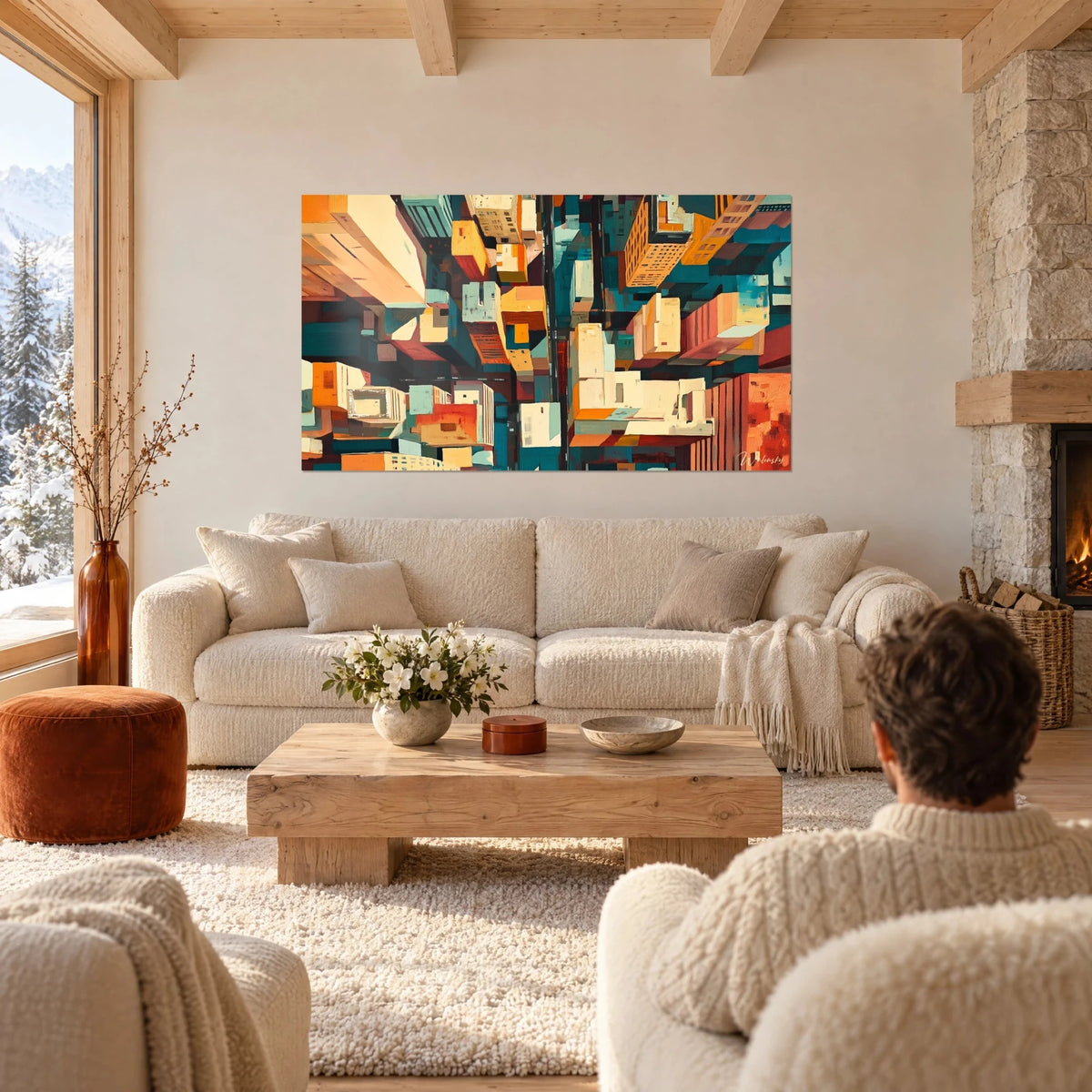 Schilderij luchtfoto van een stad in oranje en turquoise blokken, twee personen met hun rug naar de kijker boven een bank in een lichte woonkamer