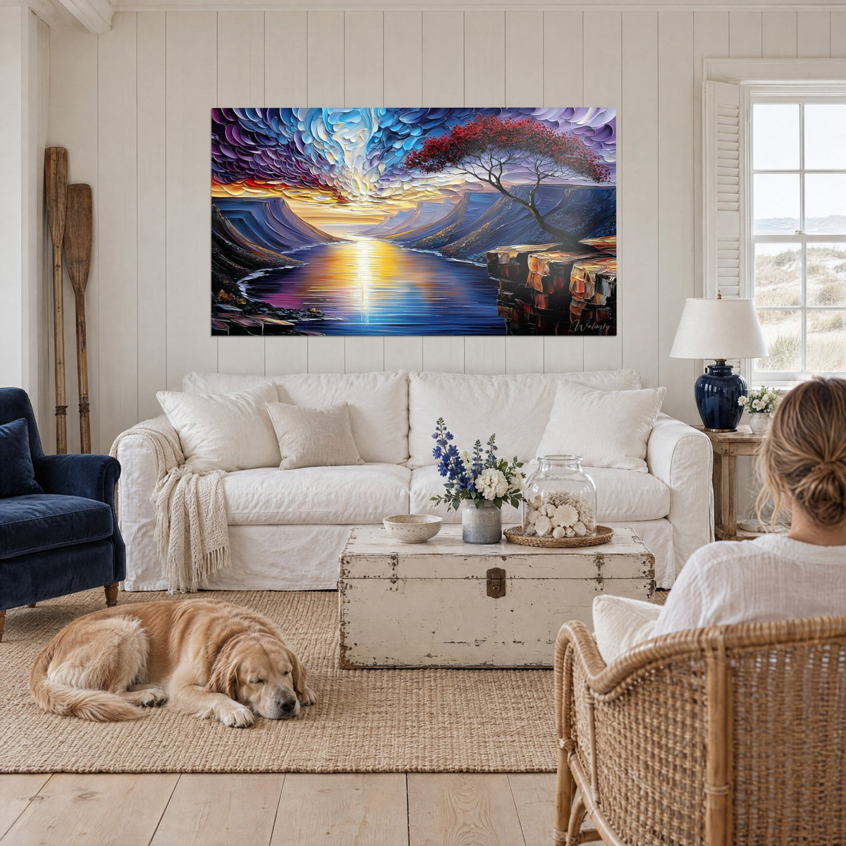 Wall art mountain lake at sunset, purple and blue sky in thick impasto, red tree, above a sofa in a bright living room