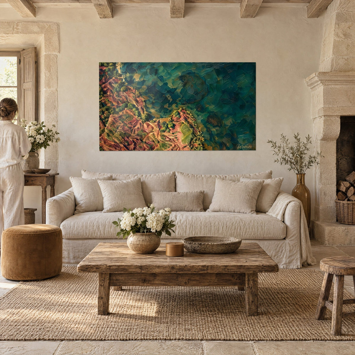 Wall art terracotta peninsula plunging into turquoise water, green and ochre brushstrokes, above a sofa in a bright living room