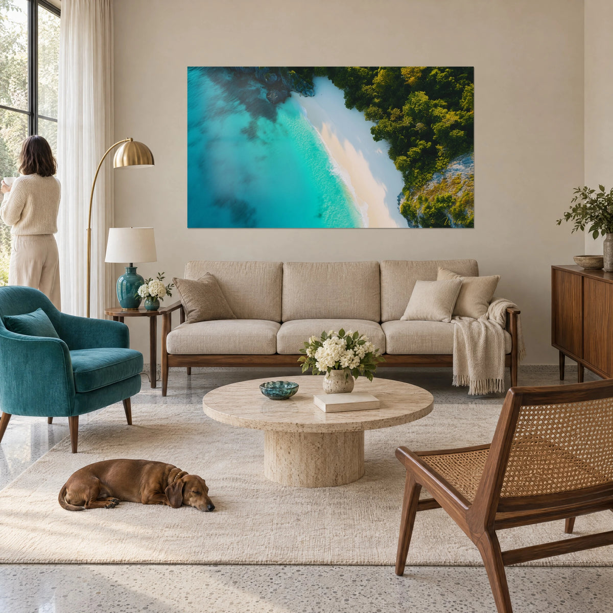 Tableau lagon turquoise vu du ciel bordé de sable blanc et de végétation verte, au-dessus d'un canapé dans un salon lumineux