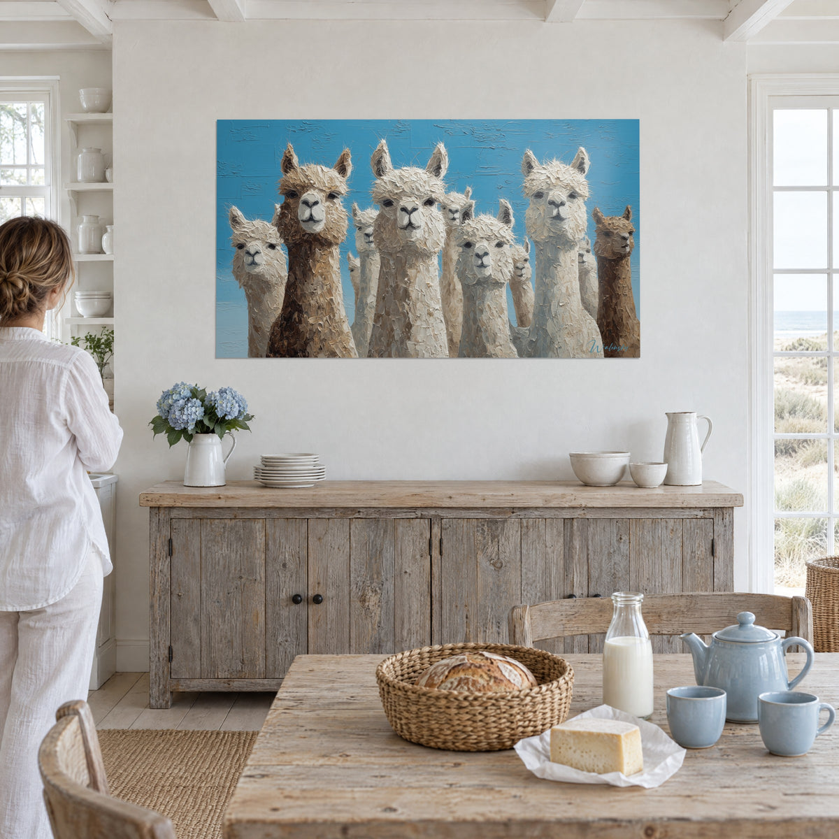 Wall art group portrait of llamas, pale muzzles, cream and hazelnut wool, blue background, woman in white seen from behind near a window