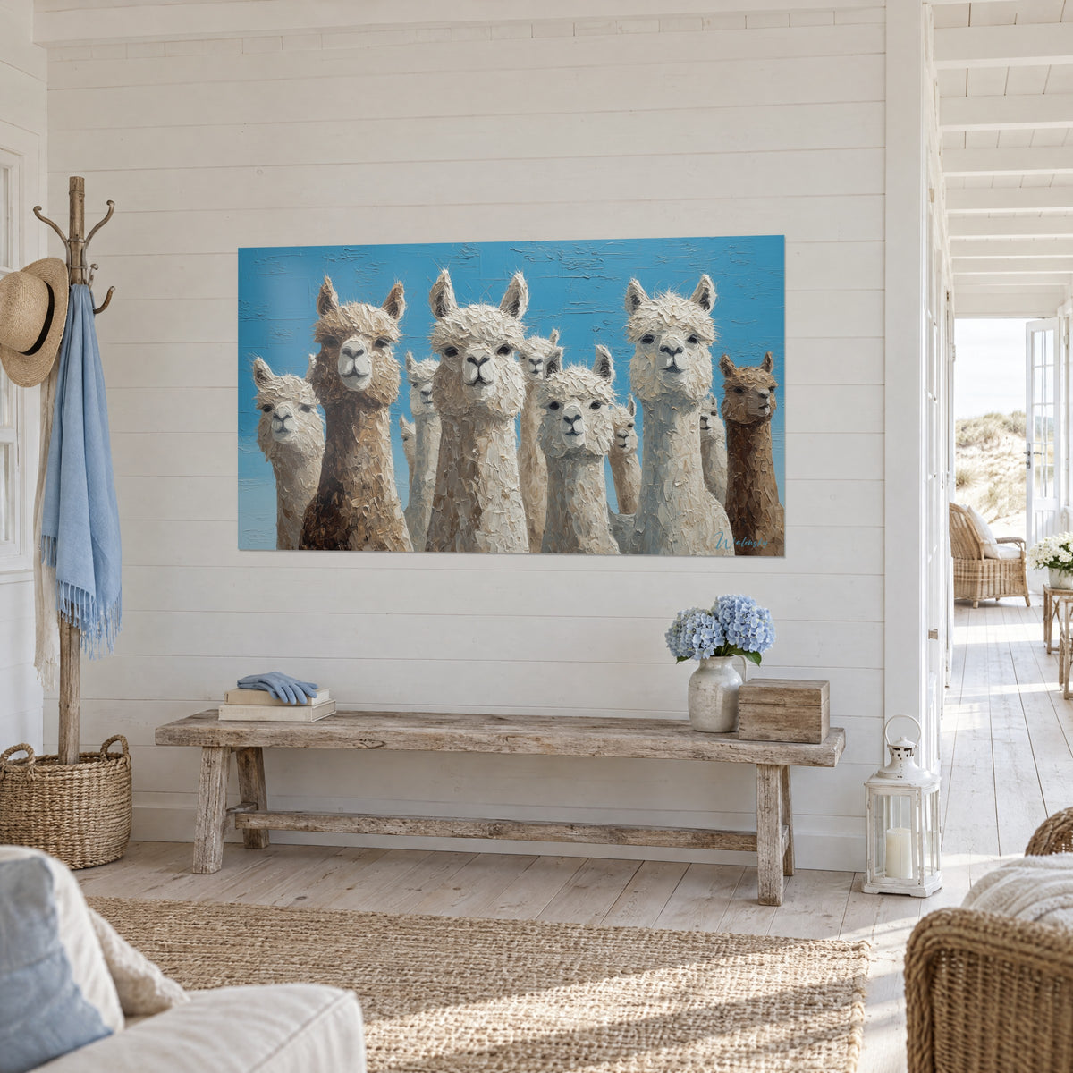 Wall art alpacas with fixed gazes, textured white and brown fleece, azure background, hung above a whitewashed wooden bench