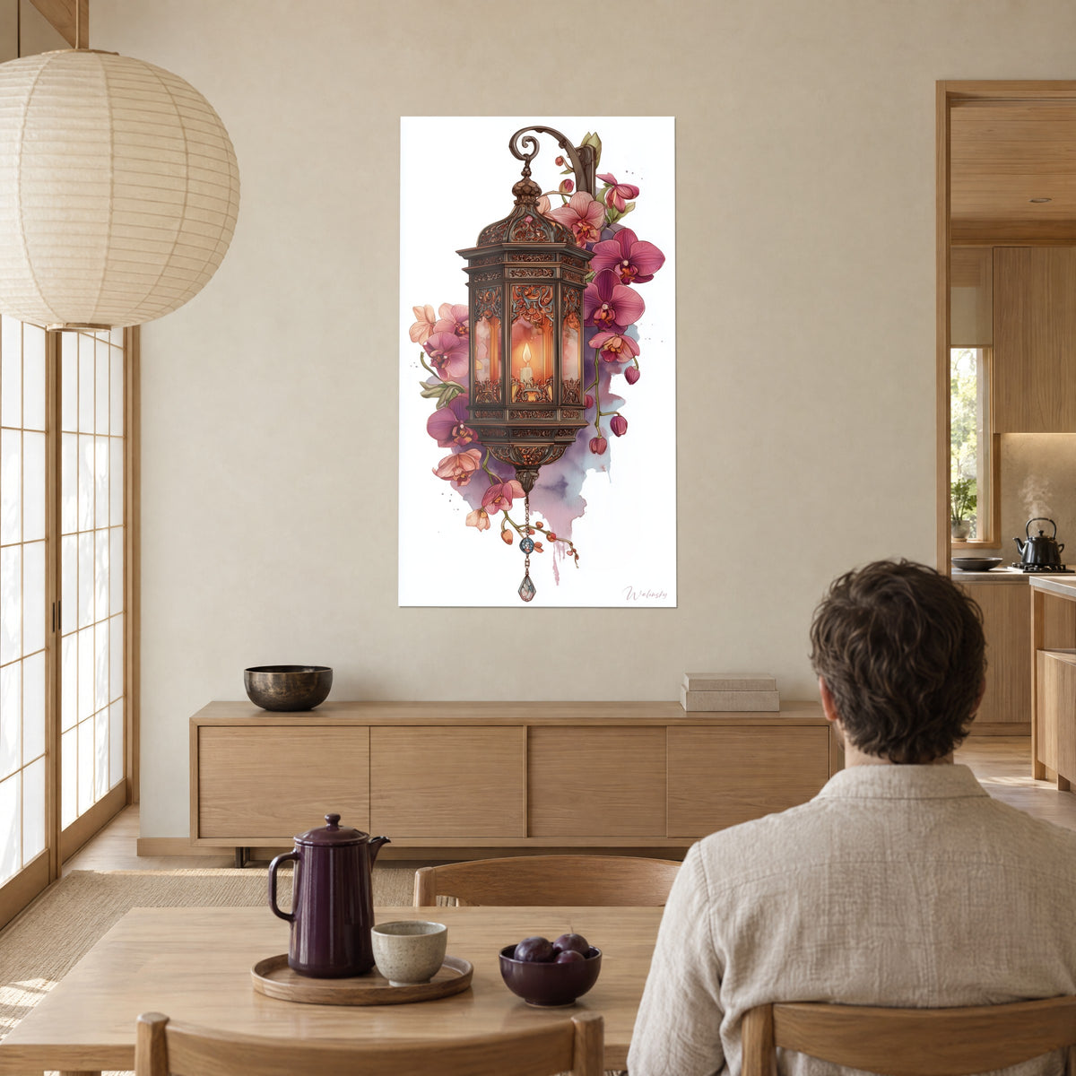 Wall art hanging lantern with metal scrolls, plum orchids and coral petals, facing a wooden dining table