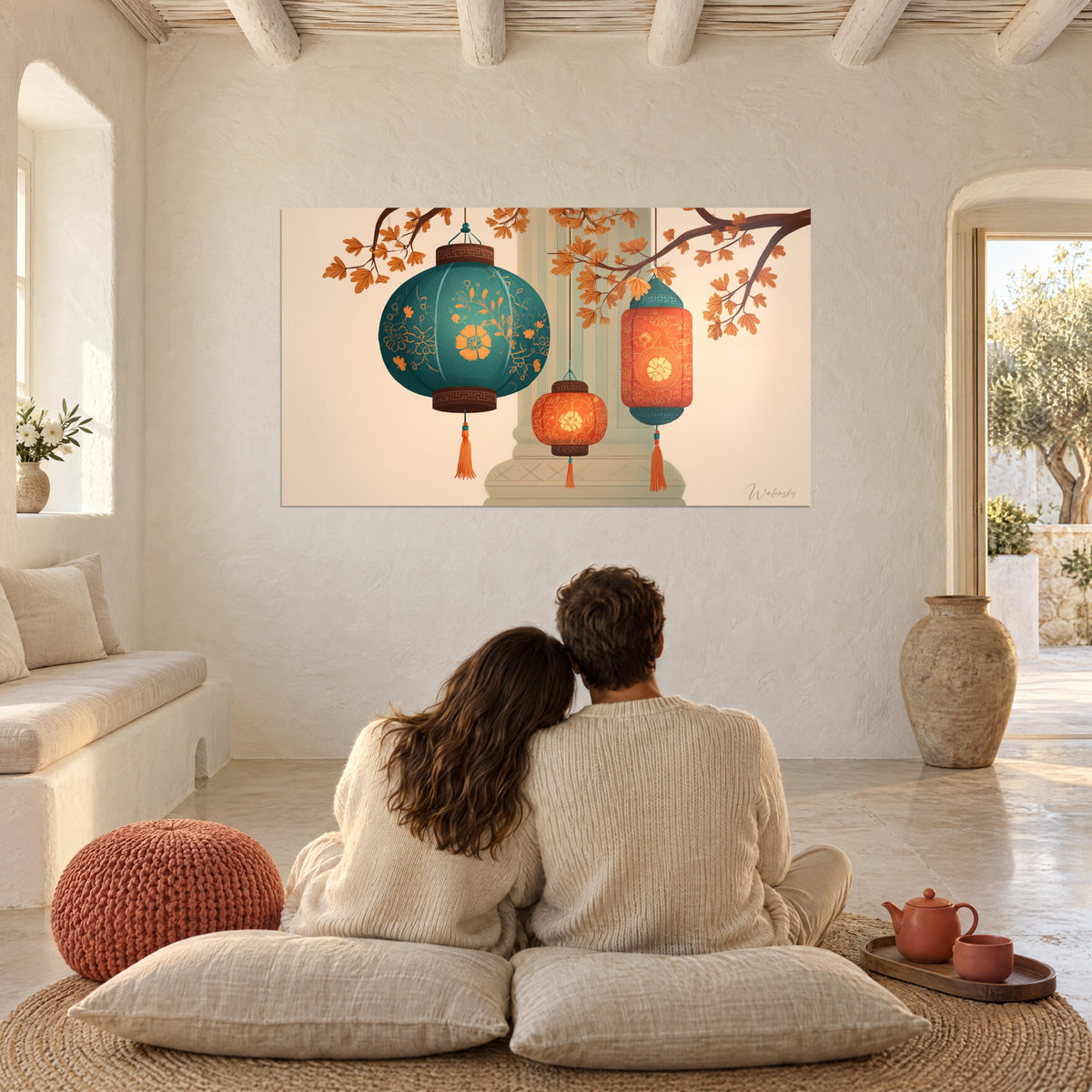 Wall art of oriental lights, turquoise and orange fringed globes, facing a couple seated back to back on cushions