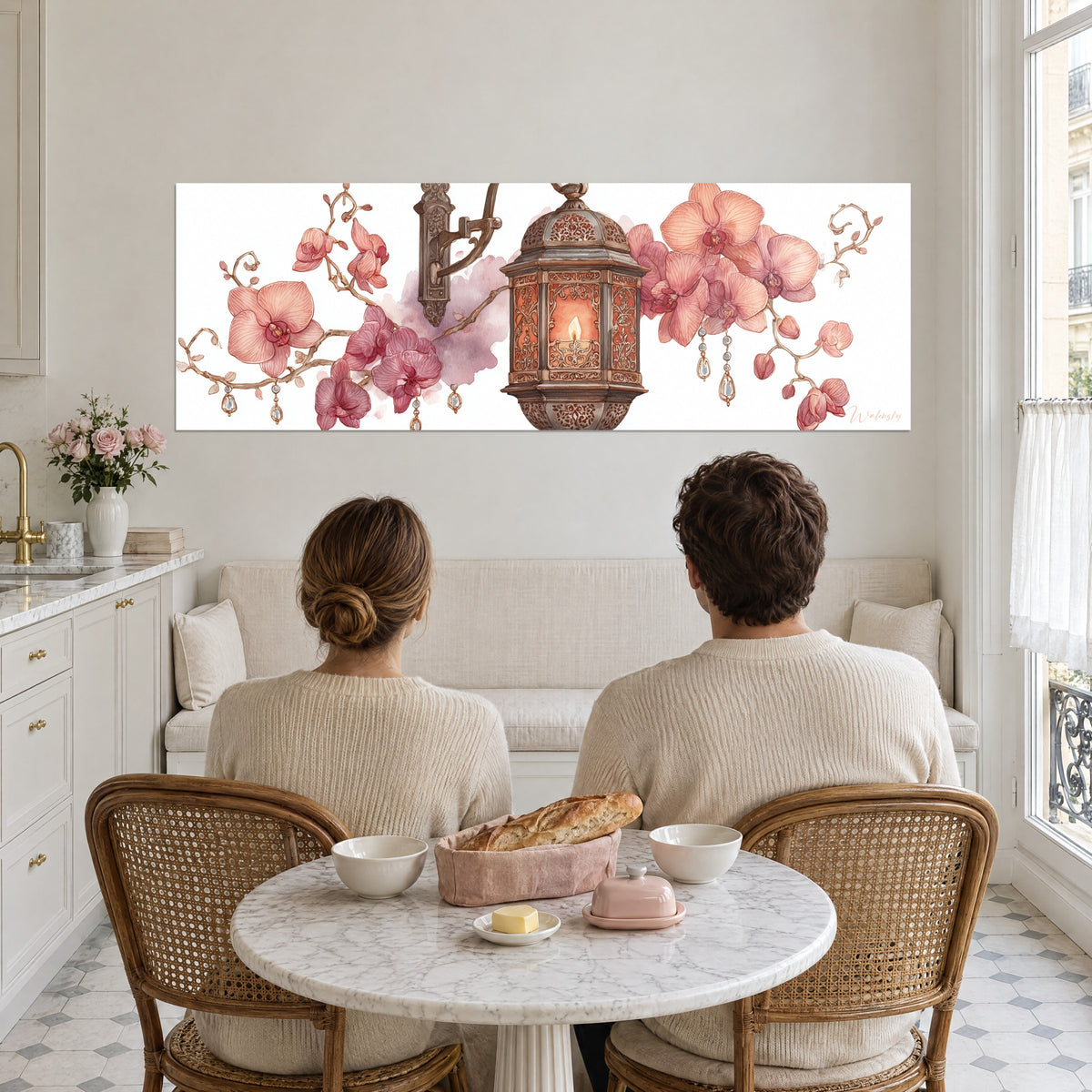 Wall art with powder-pink phalaenopsis and engraved bronze lamp, couple seen from behind seated at a round white marble table