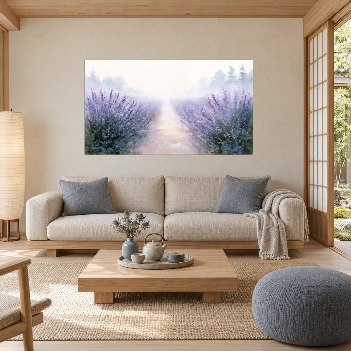 Wall art lavender field in purple blooms and sage green, pink path drowned in mist, above a sofa in a bright living room
