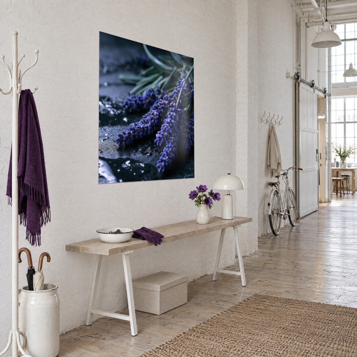 Wall art Indigo lavender flowers covered in dew, soft green stems on dark stone, white loft wall, light wood console