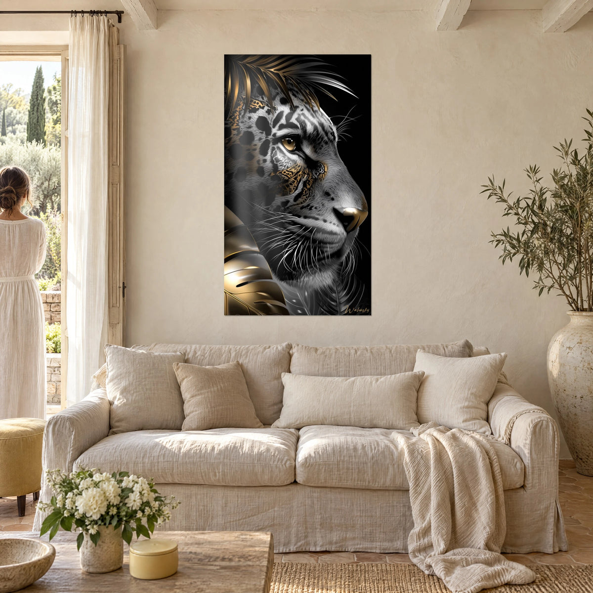 Wall art leopard in profile, silver coat speckled with black, amber eye and gold leaf, above a sofa in a bright living room