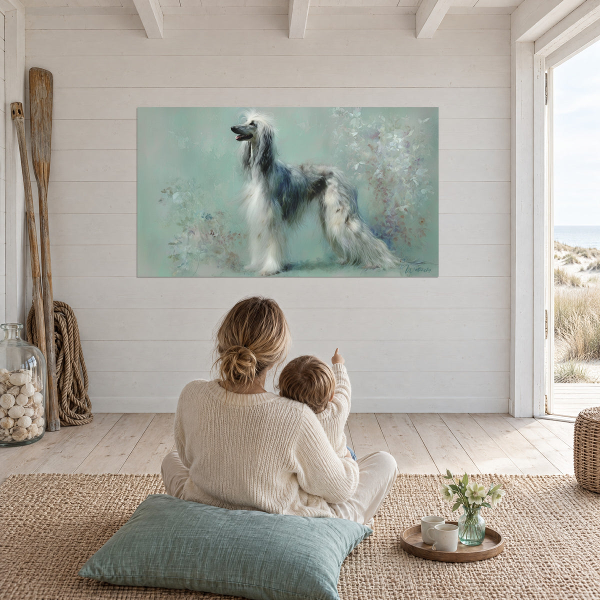 Wall art portrait of a cream and pearl-grey Afghan hound against a sea-green floral backdrop, facing a mother and child seated on a jute rug