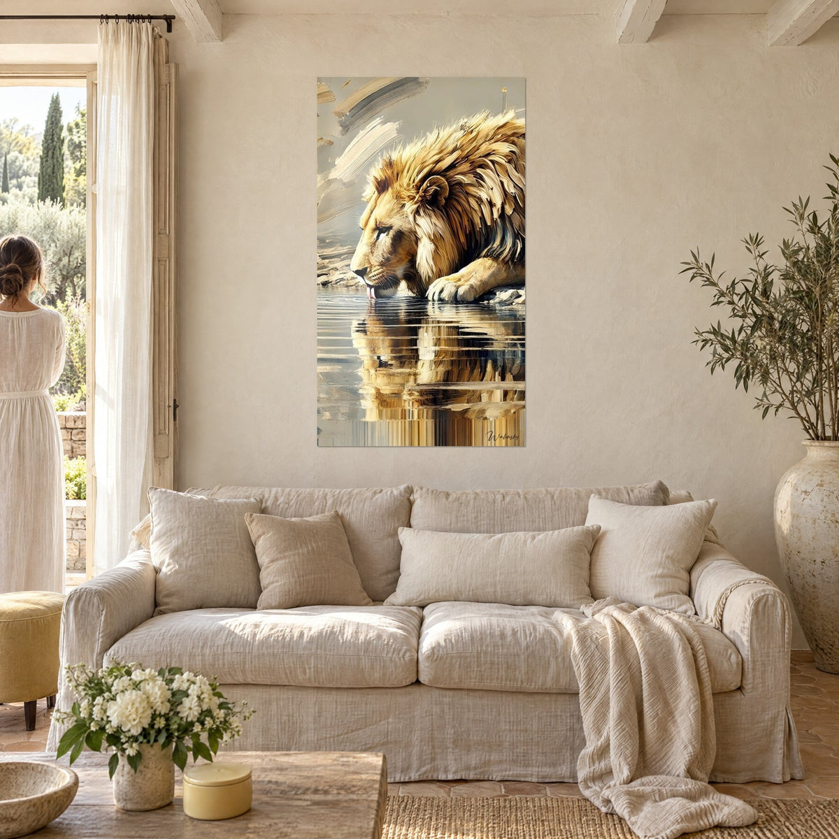 Wall art golden lion drinking, ochre mane and brown reflection in the water, woman seen from behind, above a sofa in a bright living room
