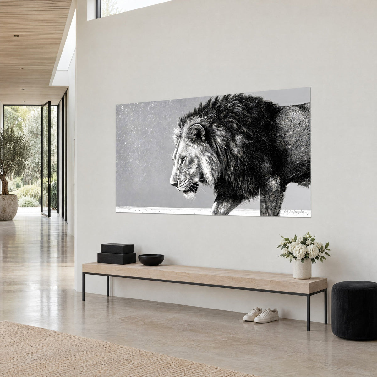 Wall art of a majestic big cat with a clear gaze, tousled black mane against a snowy grey background, three-quarter view on the wall