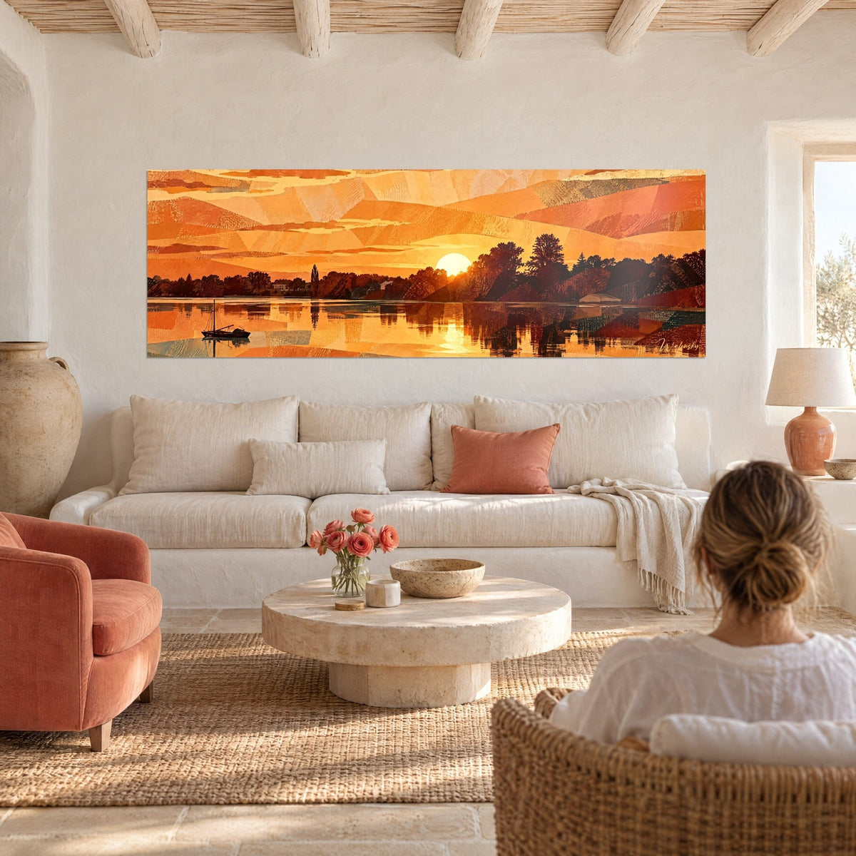Wall art orange sunset over a river, black sailboat and copper reflections, above a sofa in a bright living room