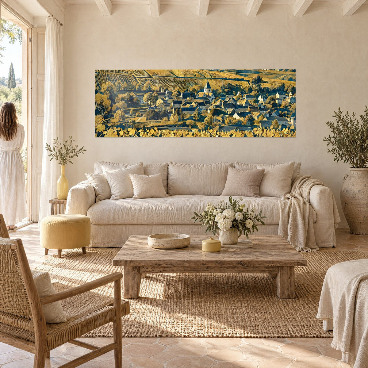 Wall art winegrowing village with slate roofs and bell tower, golden yellow and midnight blue, above a sofa in a bright living room