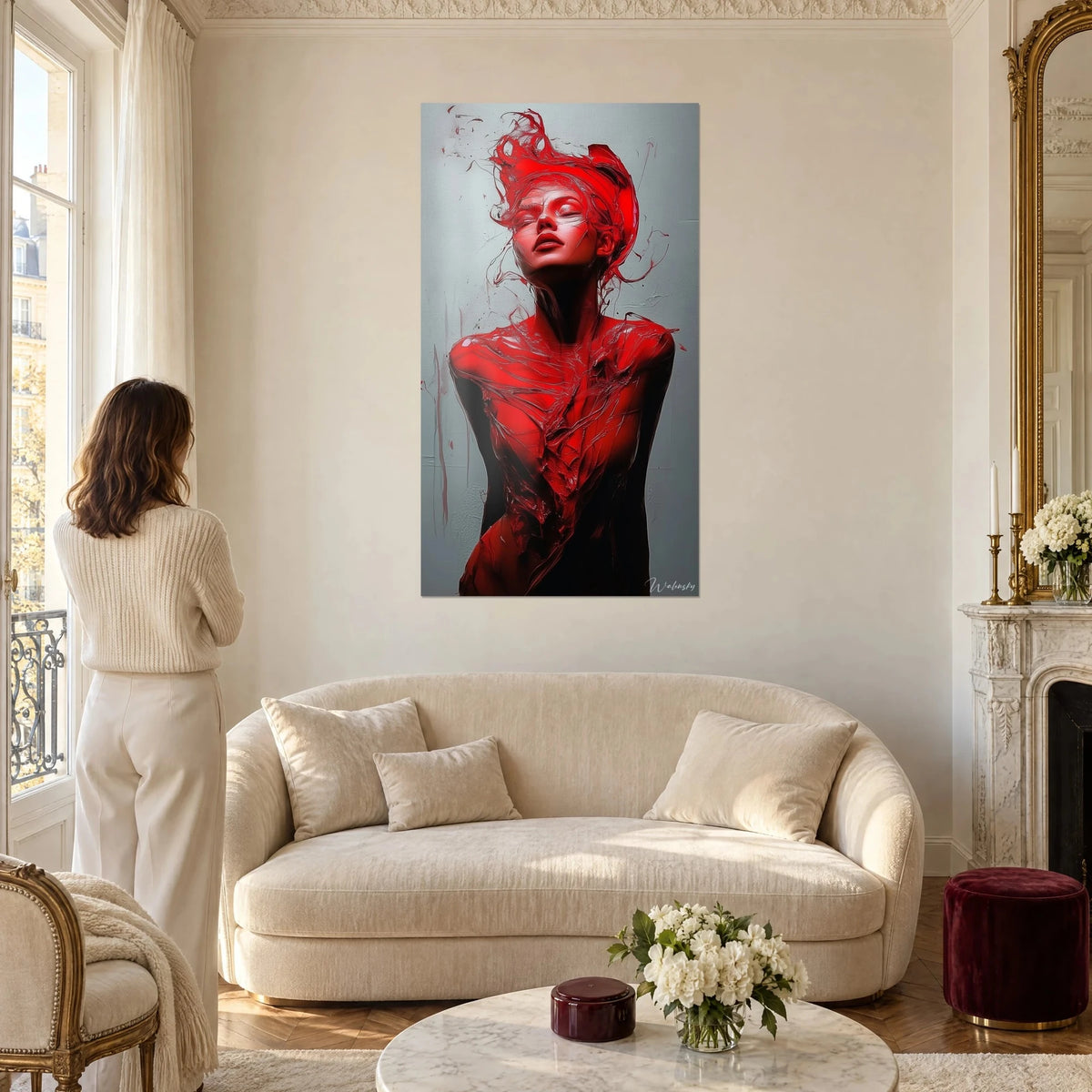 Wall art female silhouette in vermilion red, face lifted against a pearl grey background, above a sofa in a bright living room