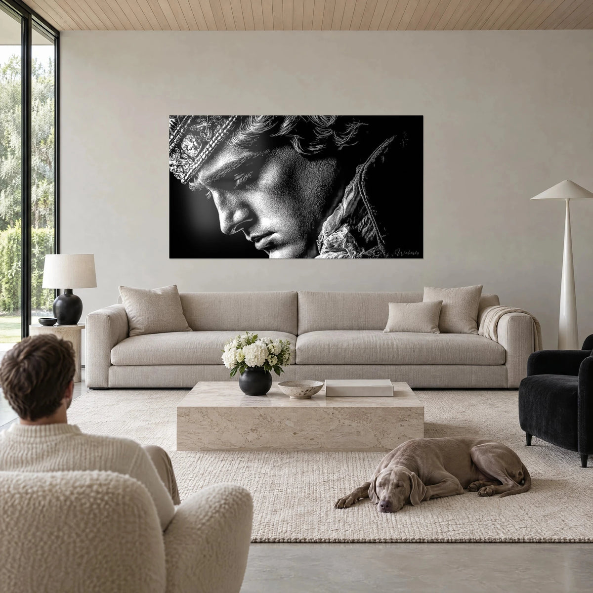 Wall art young king with downcast gaze, chiselled silver crown on black background, above a sofa in a bright living room